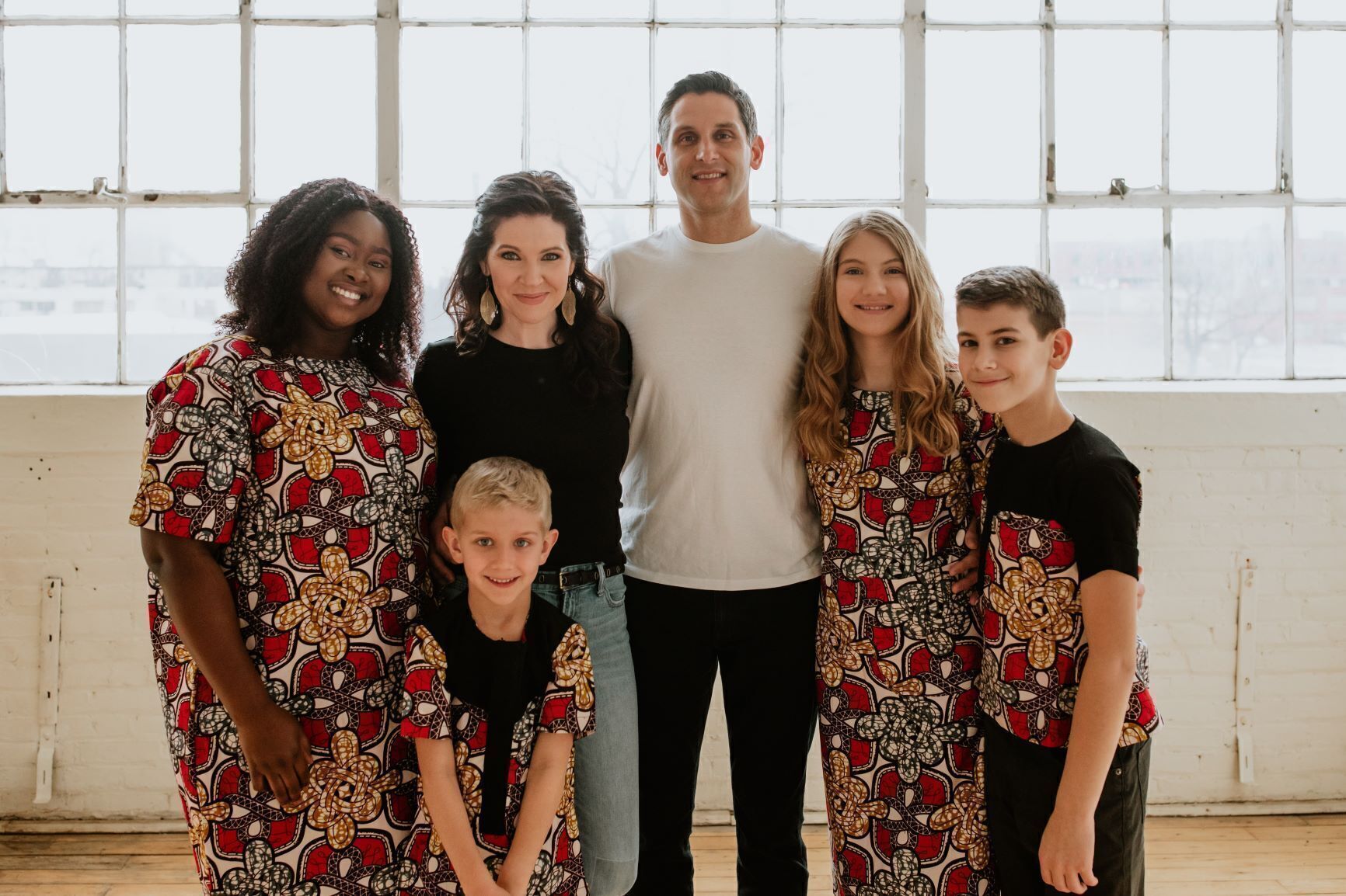 A family of six pose for a photo