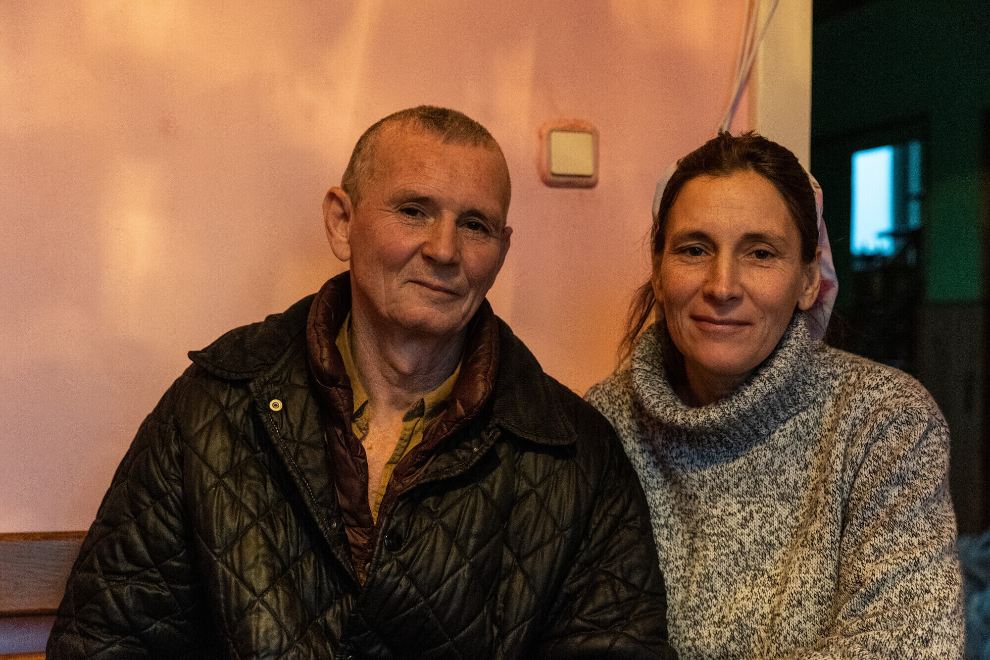 A man and woman sitting in a shelter