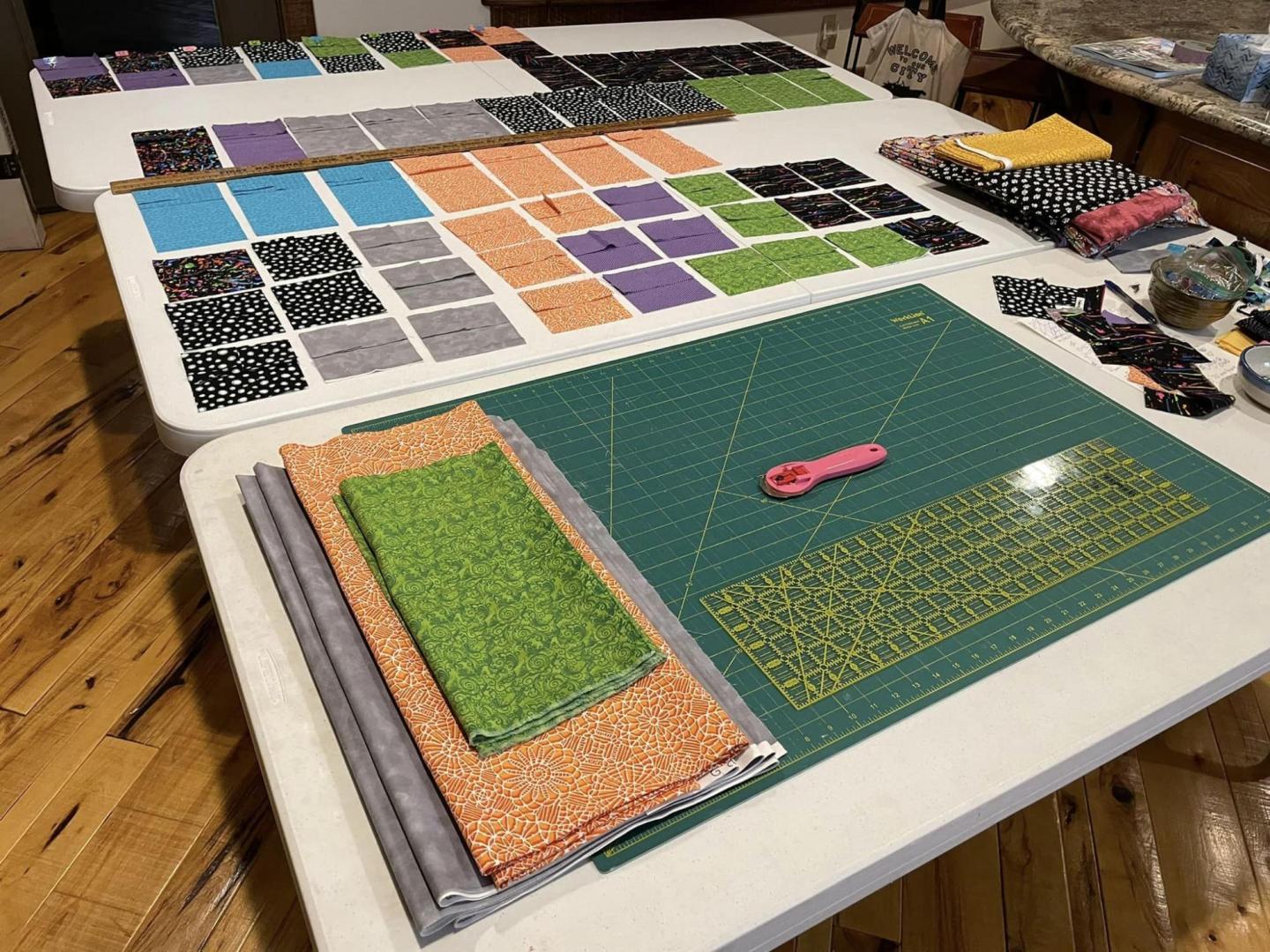 Pieces of fabric on a table with cutting tools