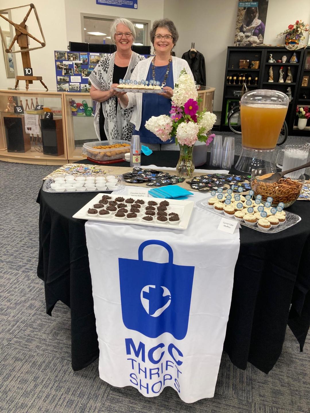 Deb King (left) and Joy Yoder (right) celebrate the grand opening of Thrift at Woodland Crossing in south-central Elkhart, Ind., on August 18, 2022. King is the MCC U.S. national thrift shop development coordinator and Yoder is MCC Great Lakes thrift shops coordinator.