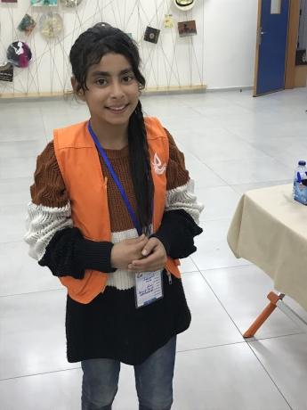 A young girl smiling for a photo