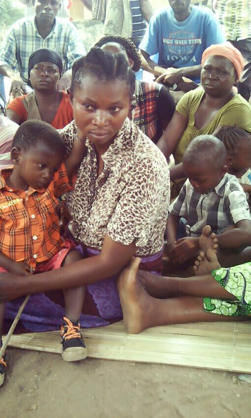 A group of people sitting on the ground