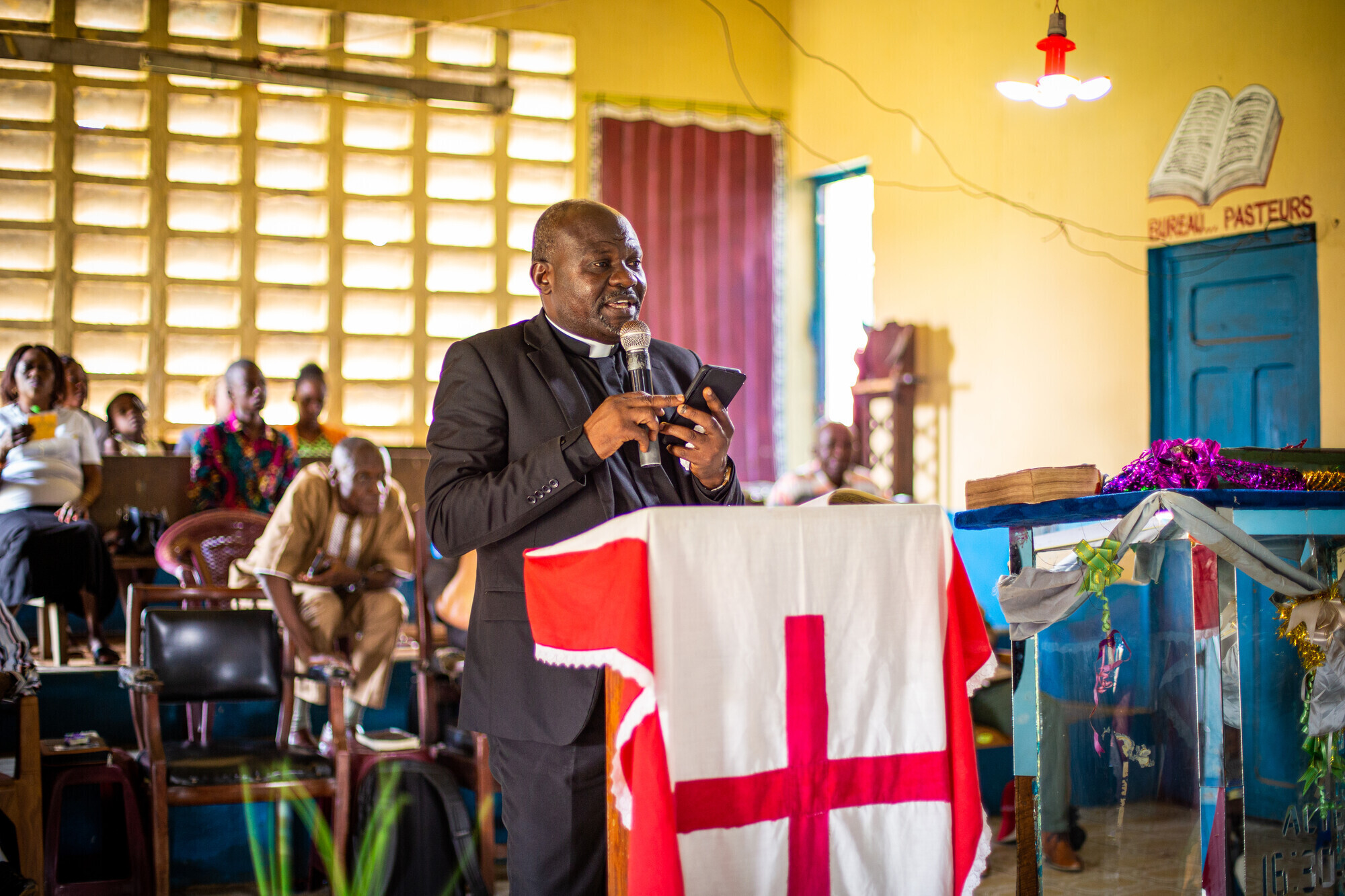 man standing at a church lectern