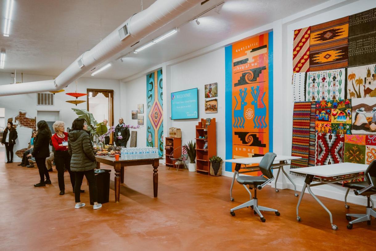 People looking at different cultural tapestries.