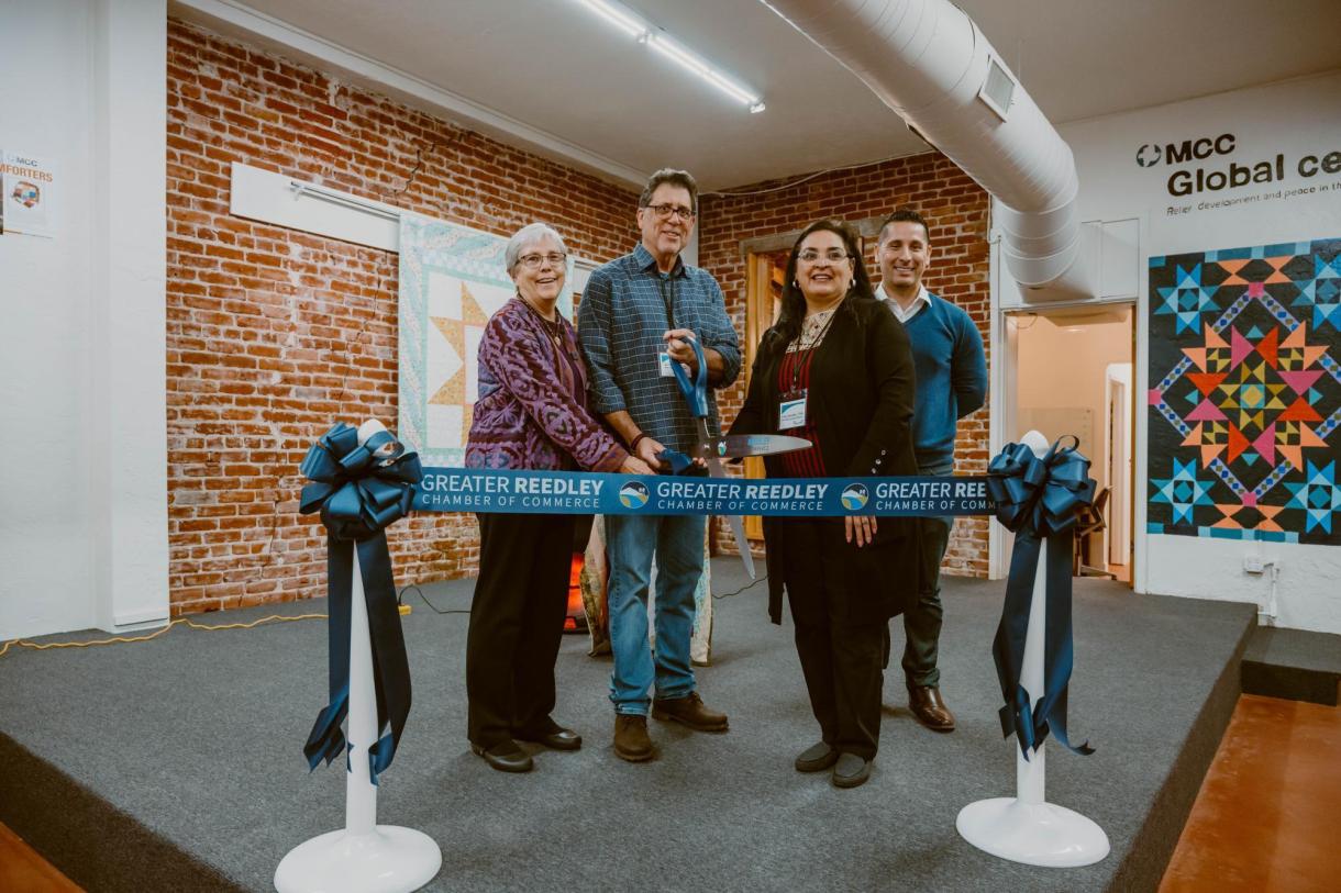 A group of people clipping an opening ribbon