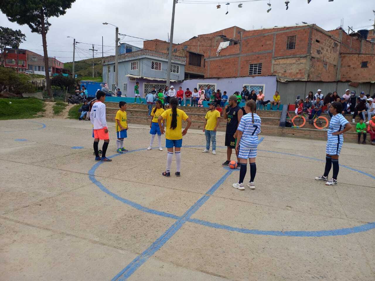 Children playing soccer/football in a school yard in Colombia