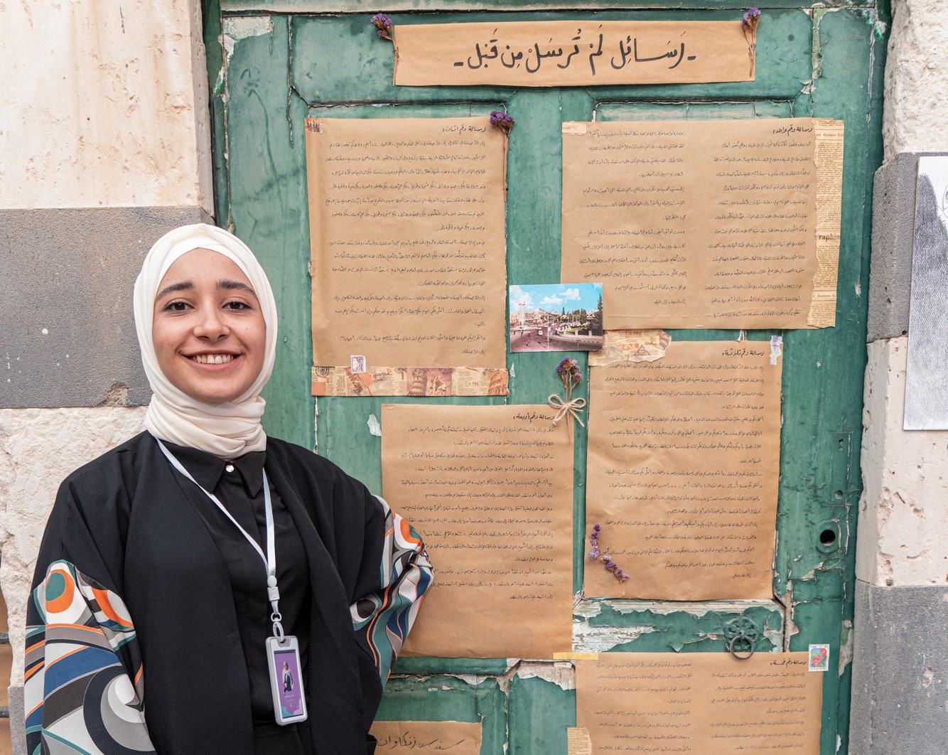 A young woman standing in front of an art installation