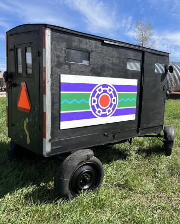 An Amish buggy that has been painted with a mural