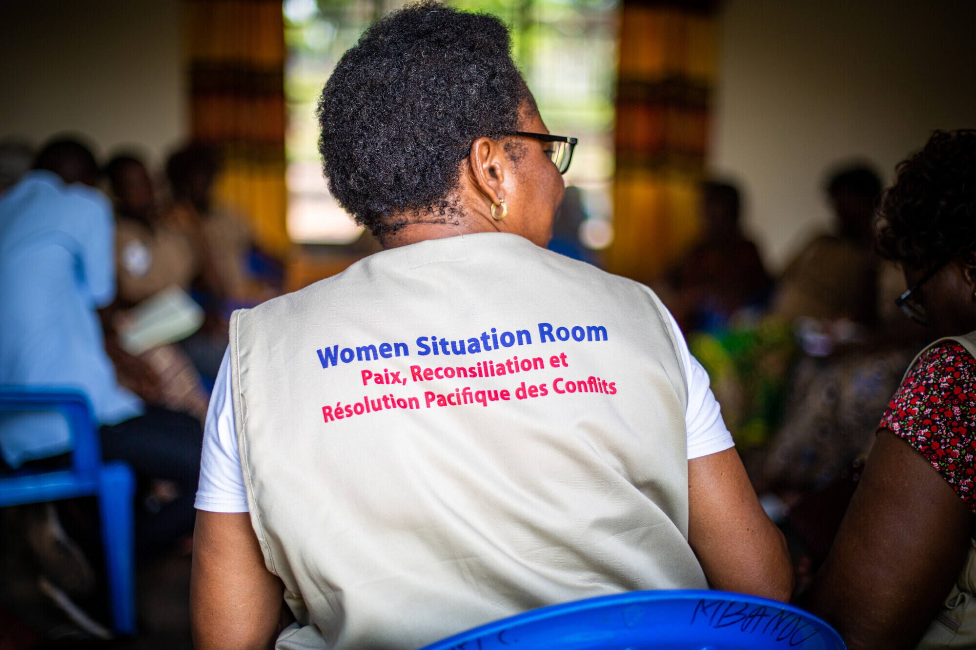 back of woman wearing women situation room vest