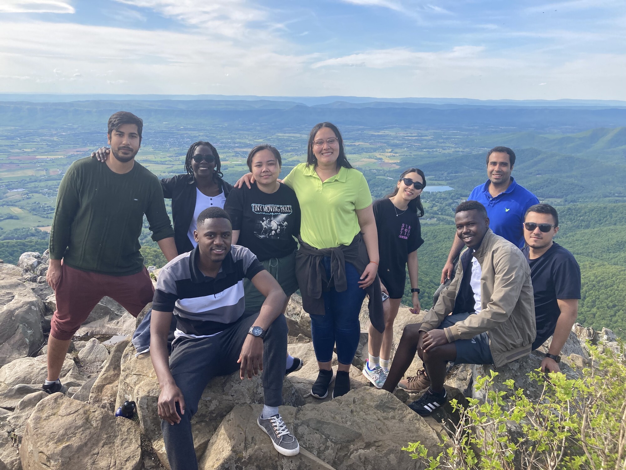 A group of young adults standing near an overlook of a valley