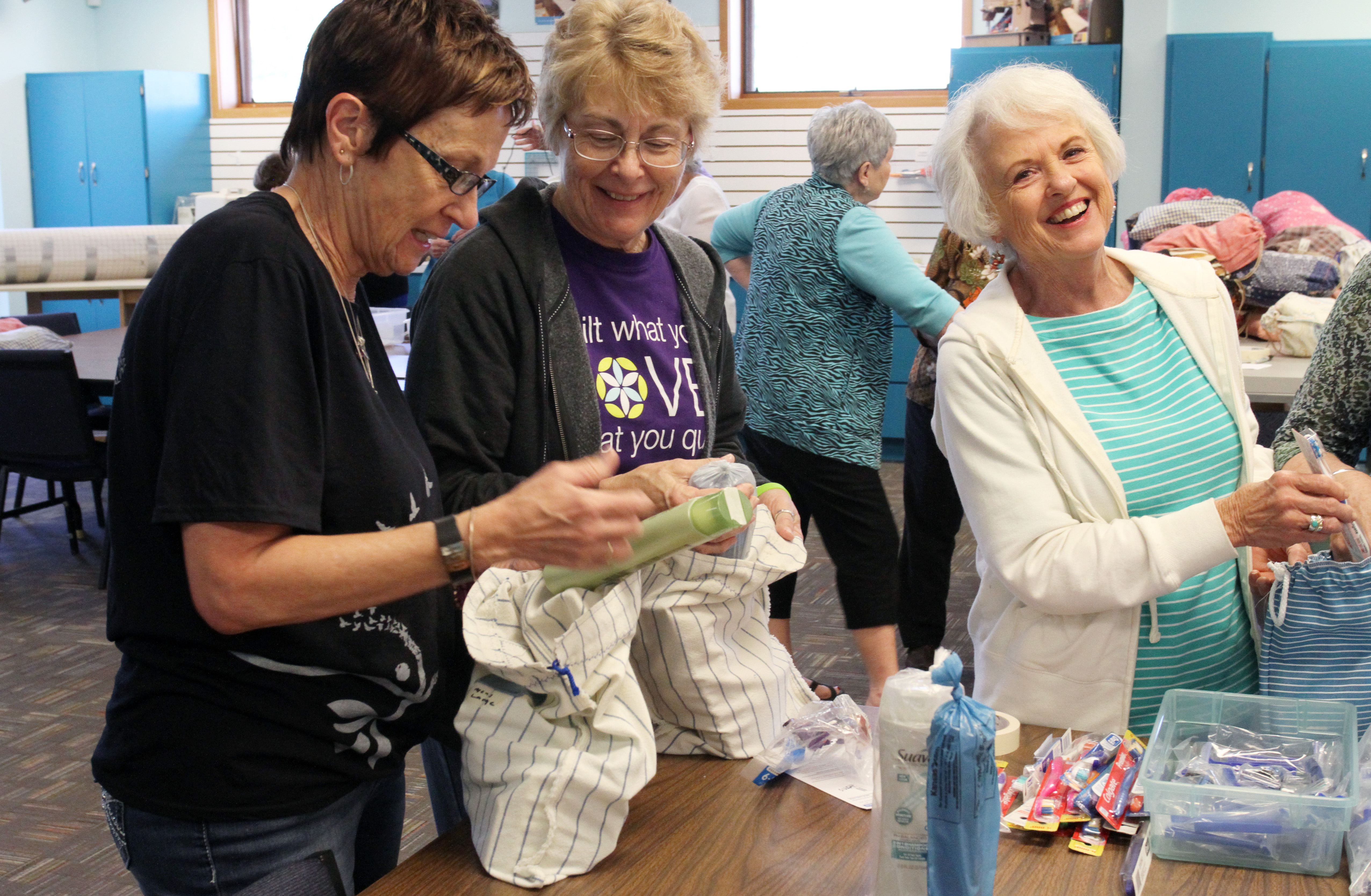 Volunteers Barb Voth, Edda Schlund and Carol Ott from Bethesda Mennonite Church in Henderson, Kansas, work together to put together returning citizen care kits at MCC Central States Material Resources Center in North Newton, Kansas. 