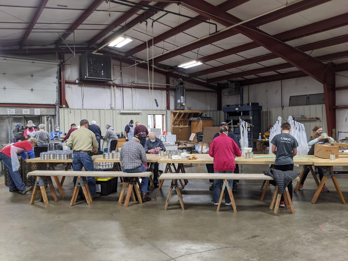 Volunteers from local churches put labels on meat cans at the MCC Material Resources Center in North Newton, Kansas, in November 2020.