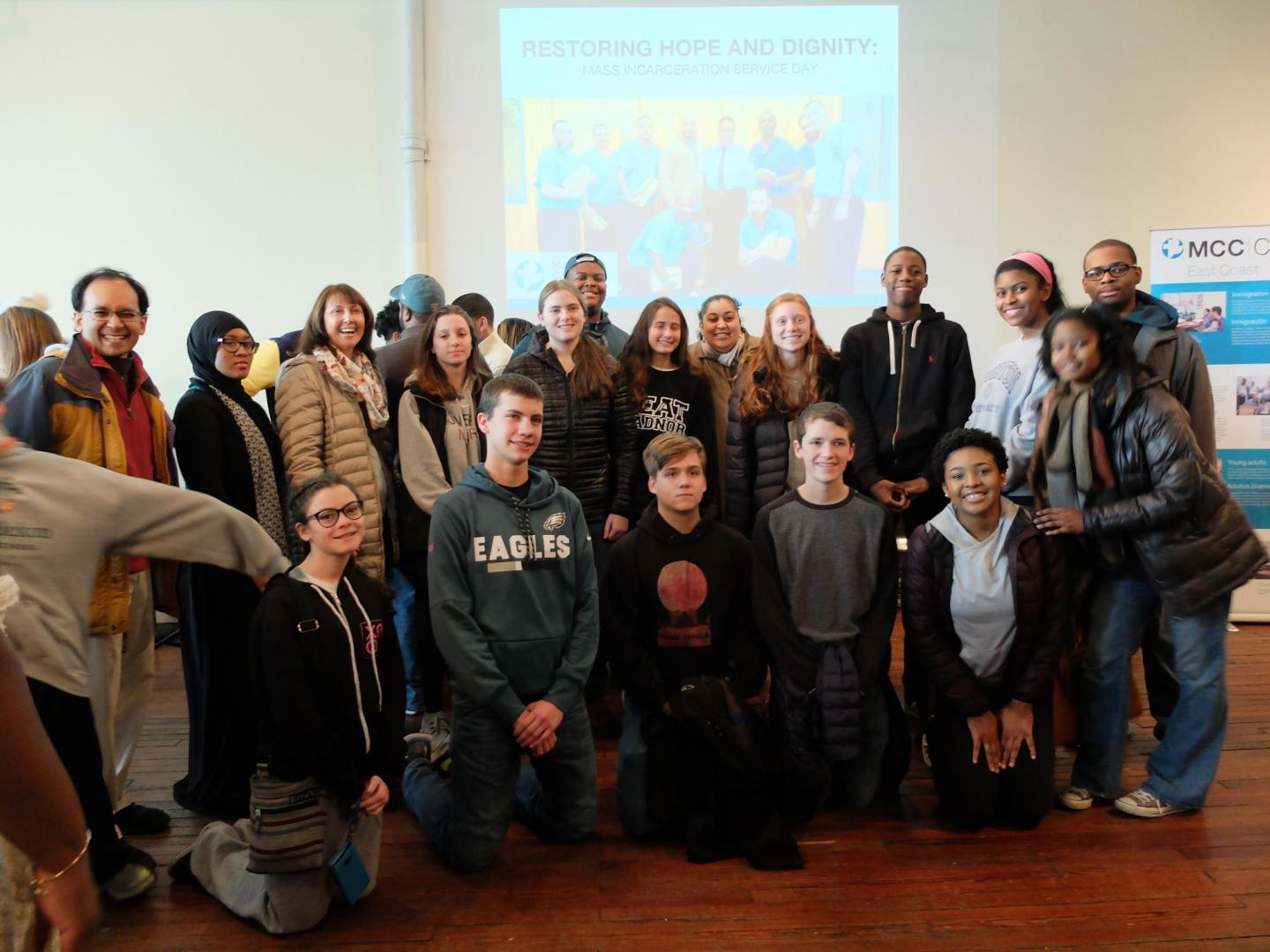 A large group of students pose in two rows for a photo