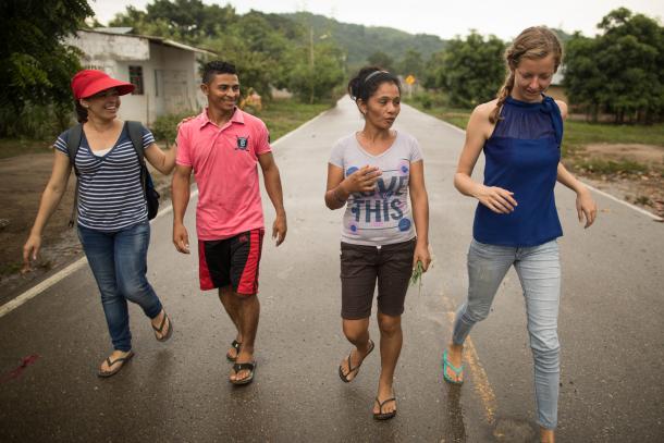 A group of young people walking down a road