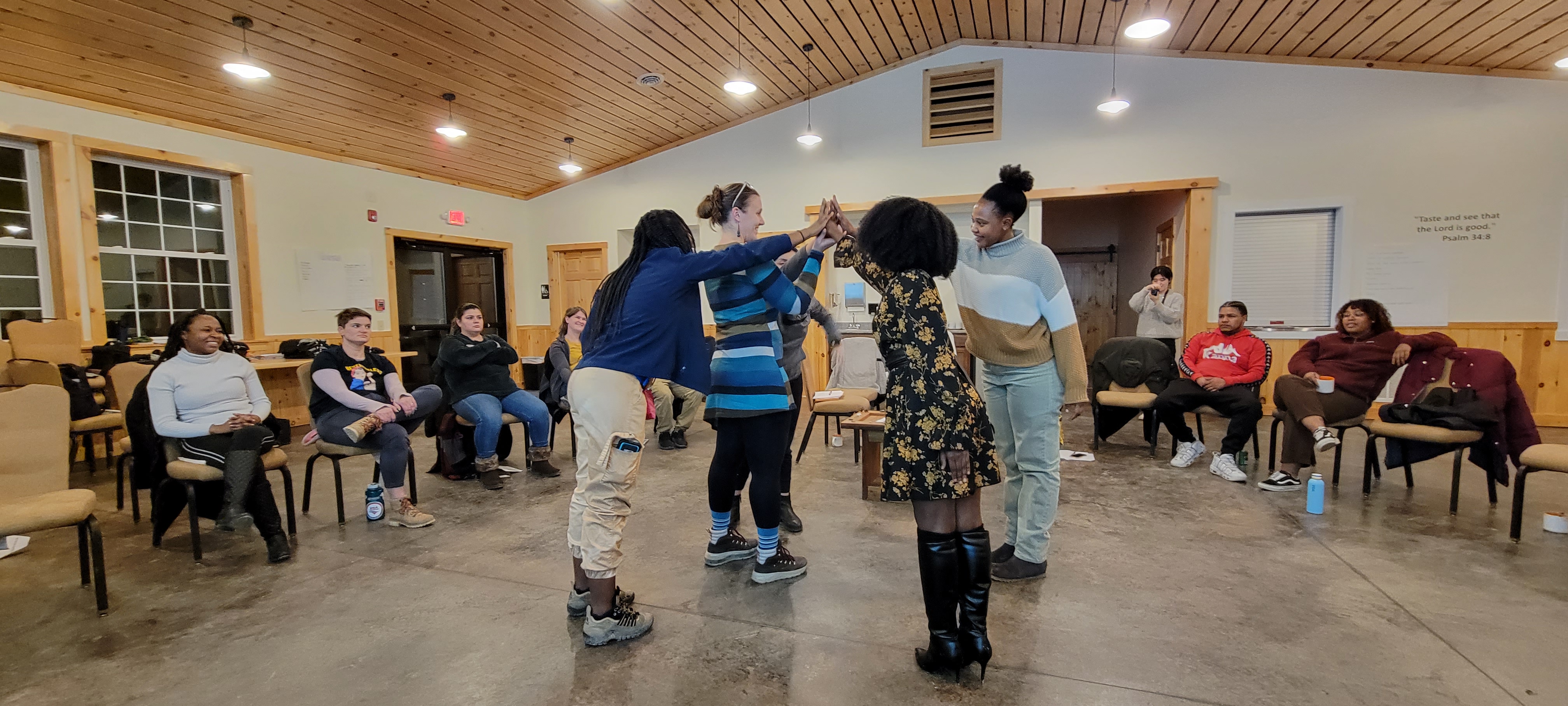 A group of people stand in a circle/