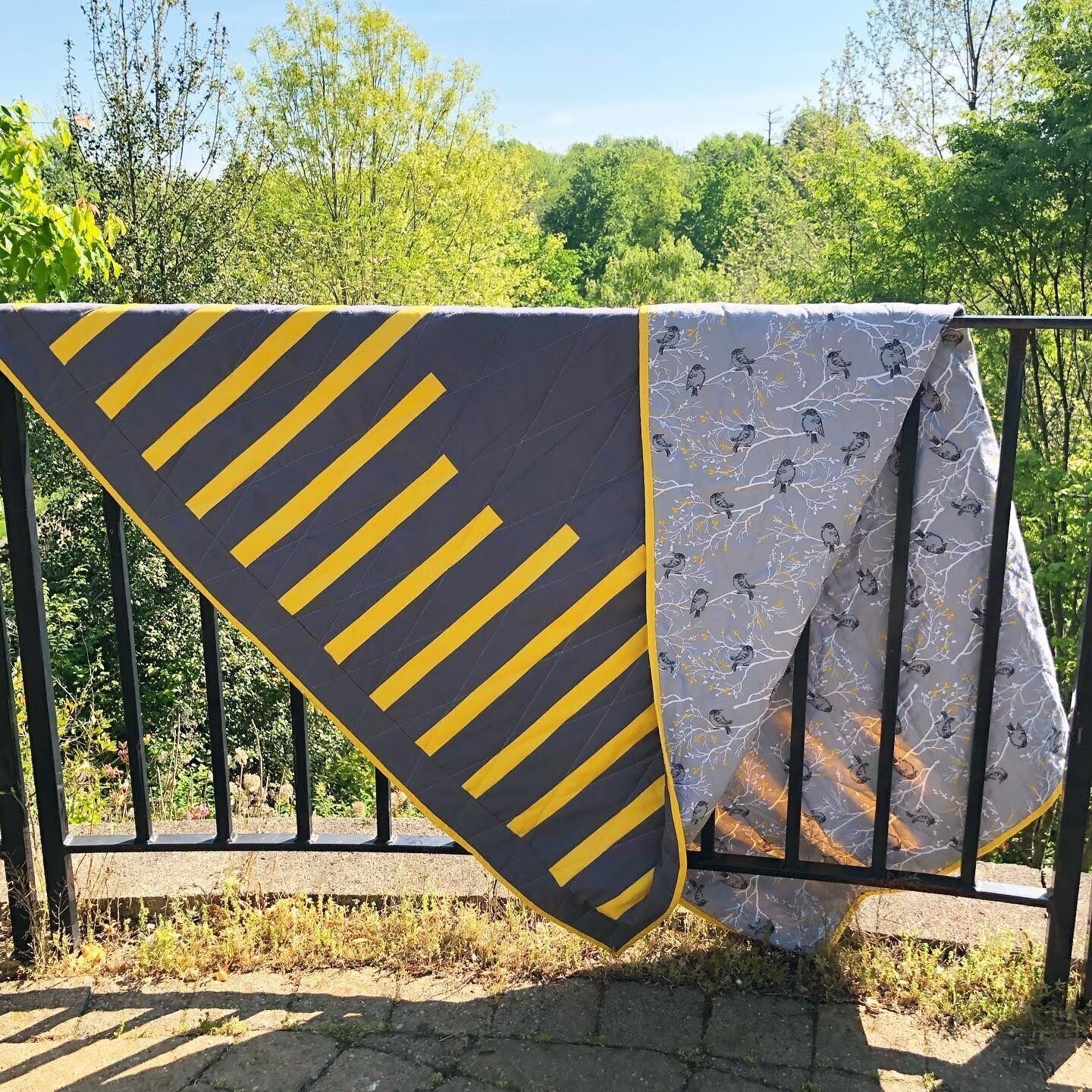 A grey and yellow quilt