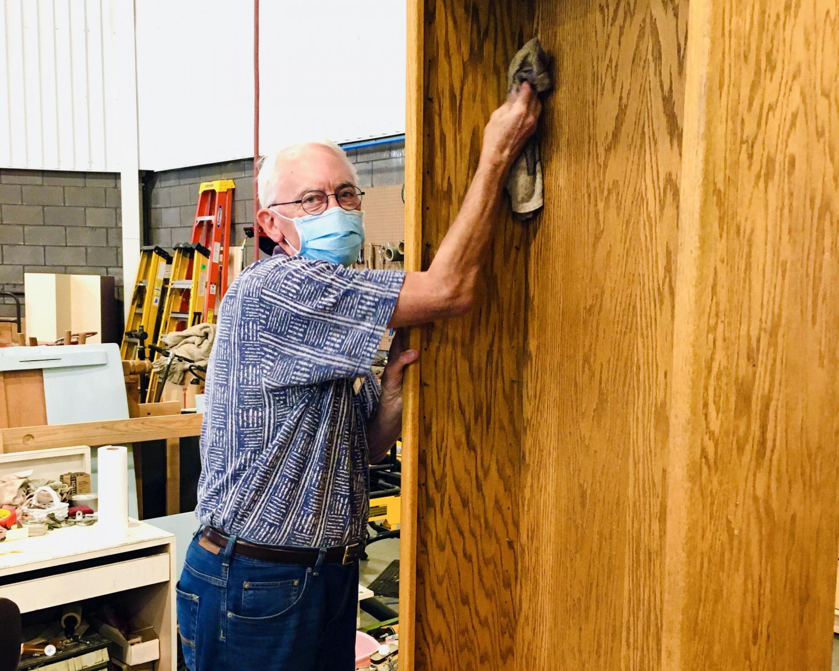 A man cleaning furniture