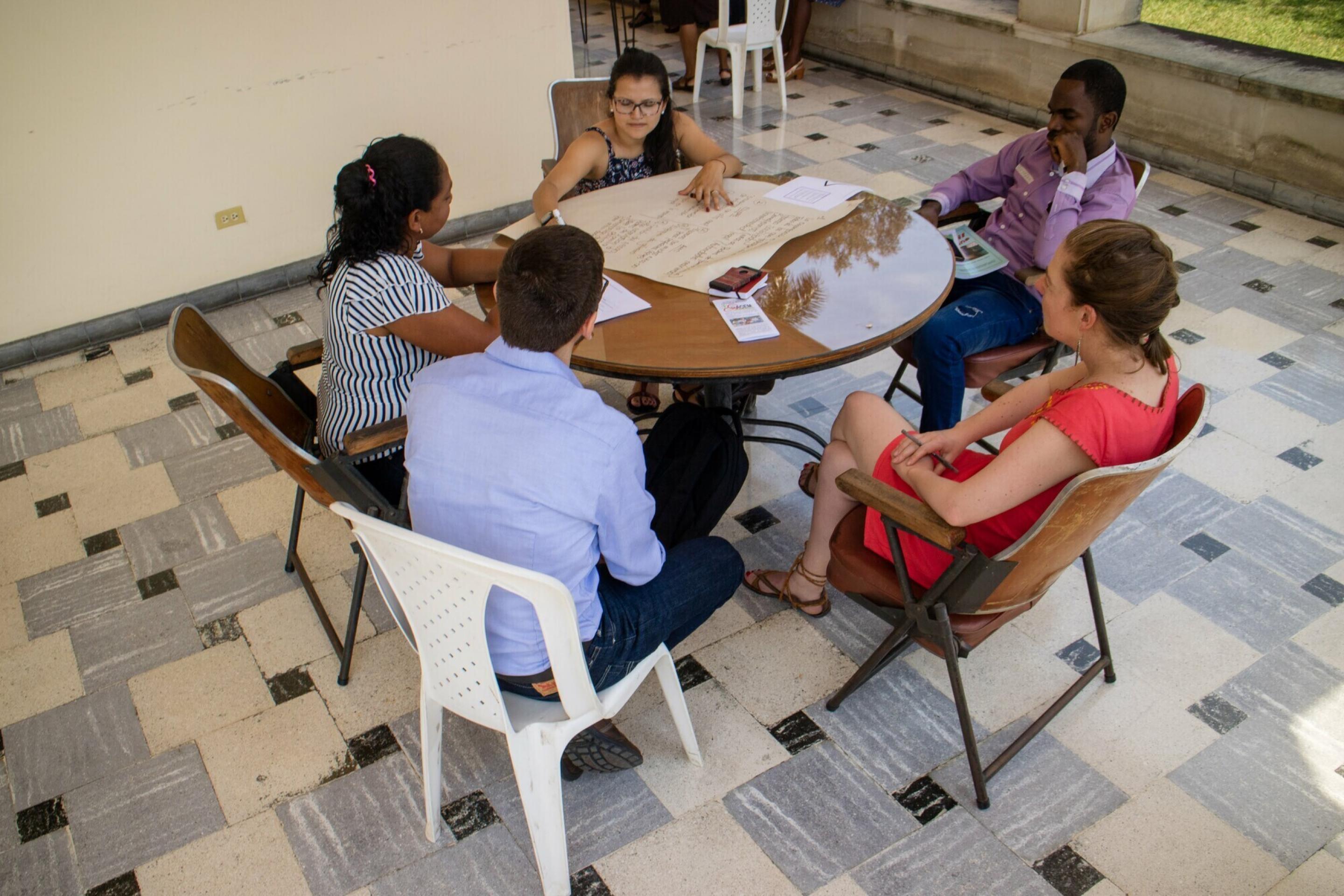 A group of people sitting around a table