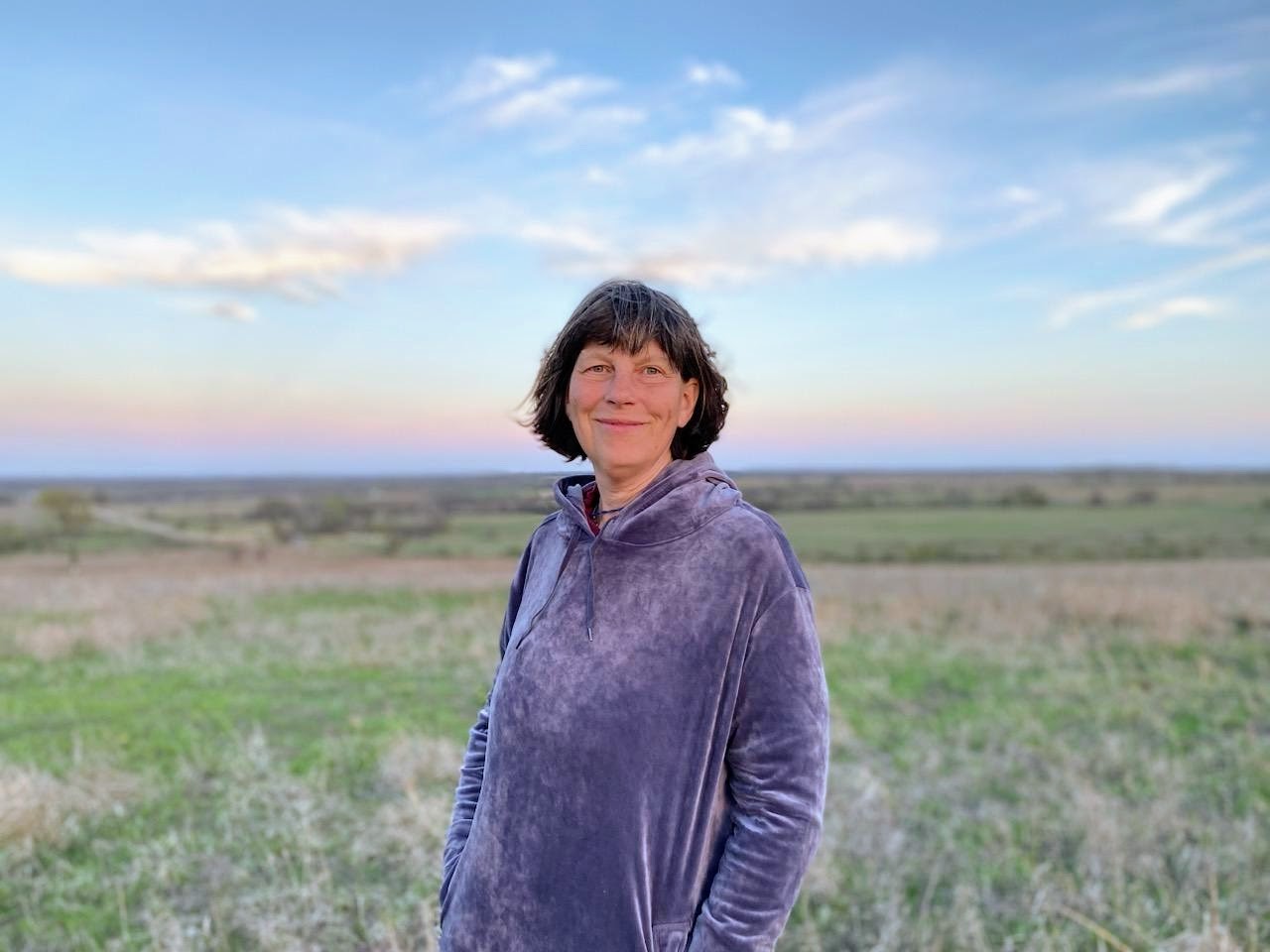 A woman standing on a field.