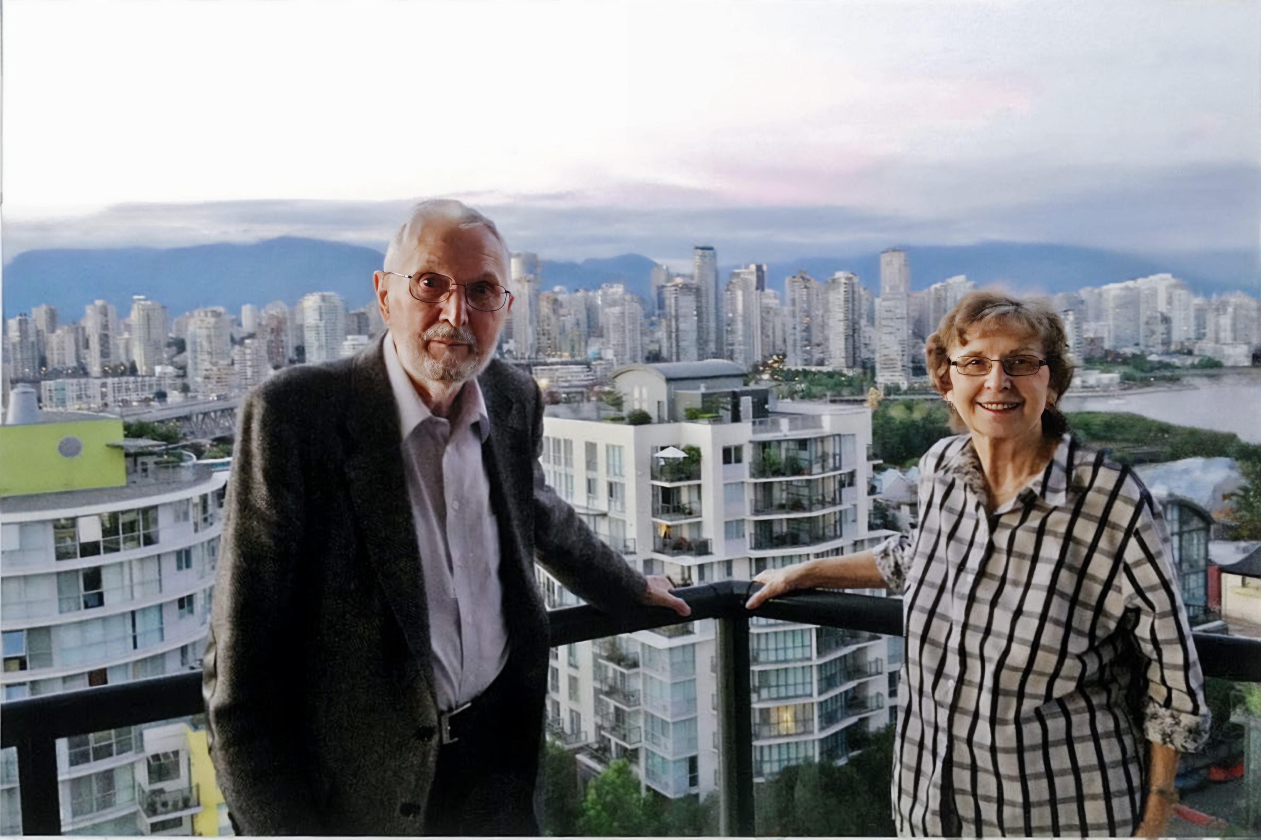 A man and woman standing in front of a city skyline 