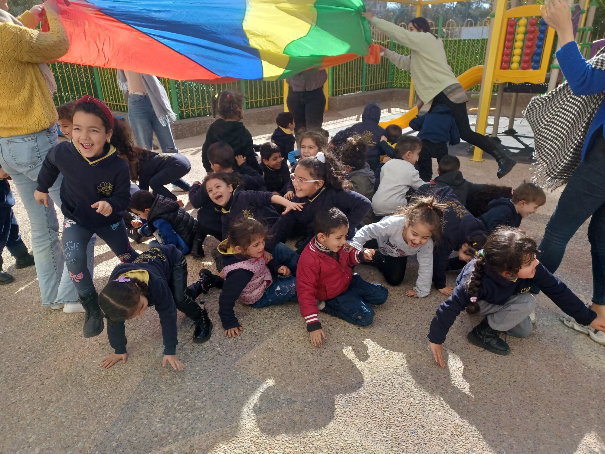 Children playing under a parachute