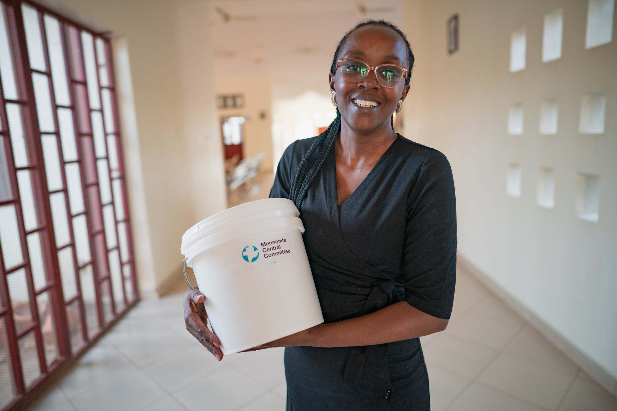 Women holding dignity kit bucket