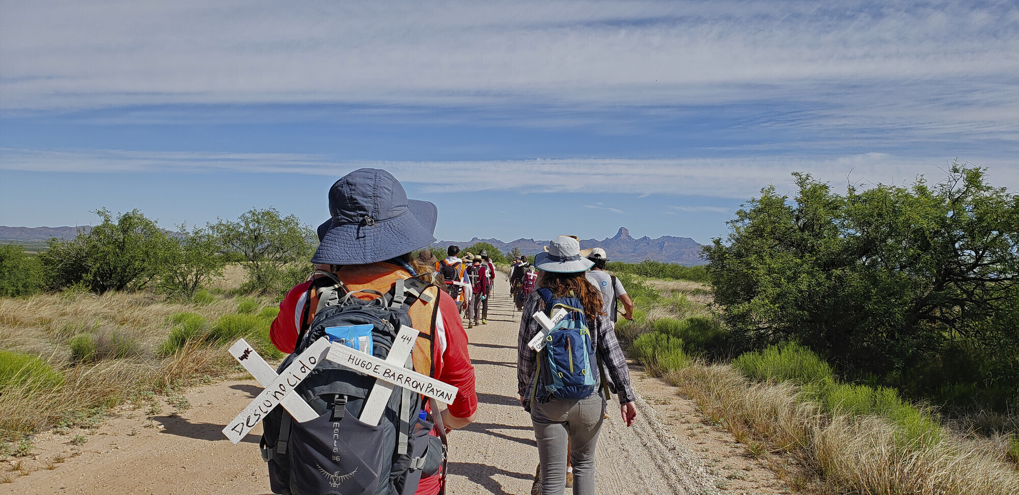 A group of people walking down a road