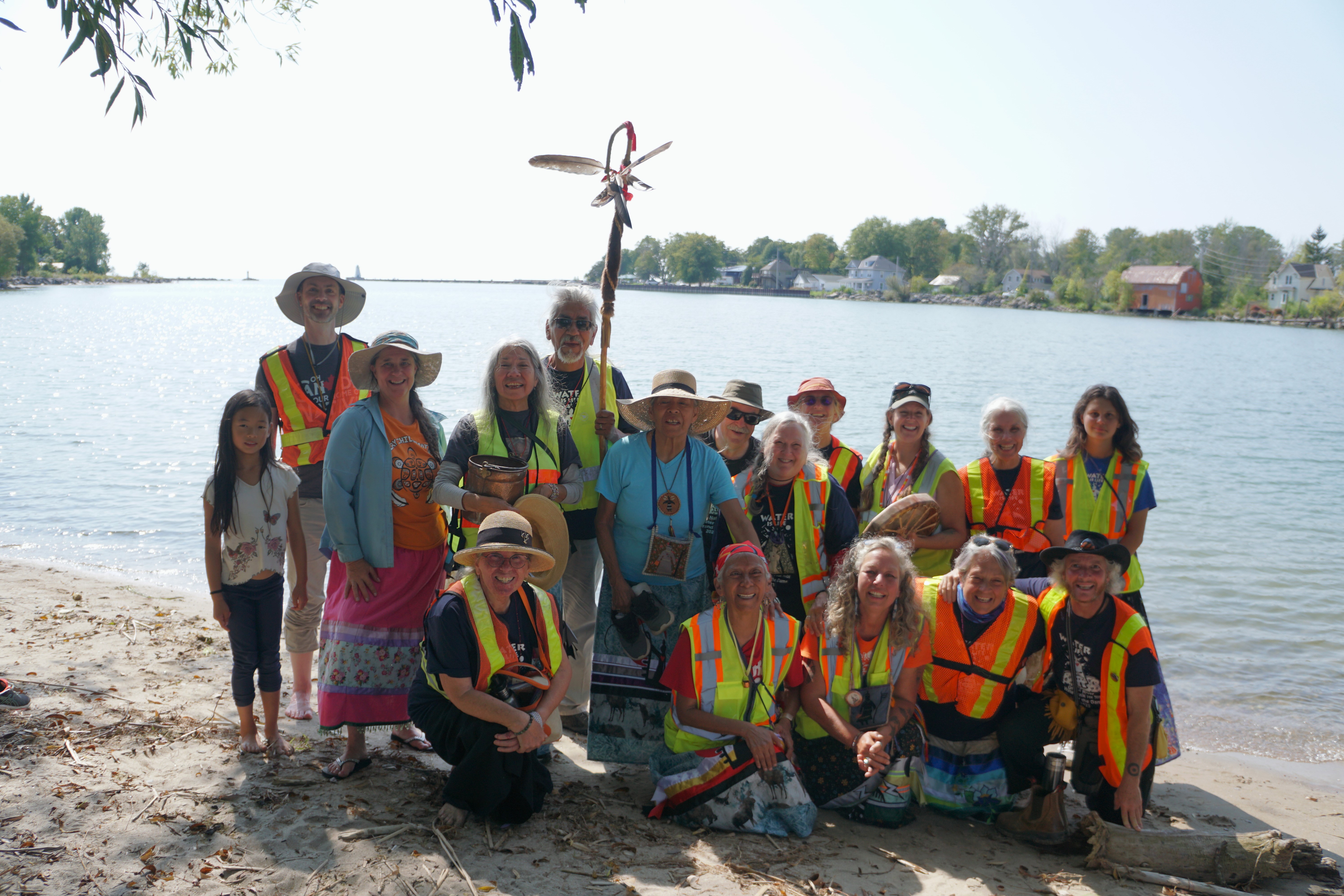 Group of people in front of lake.