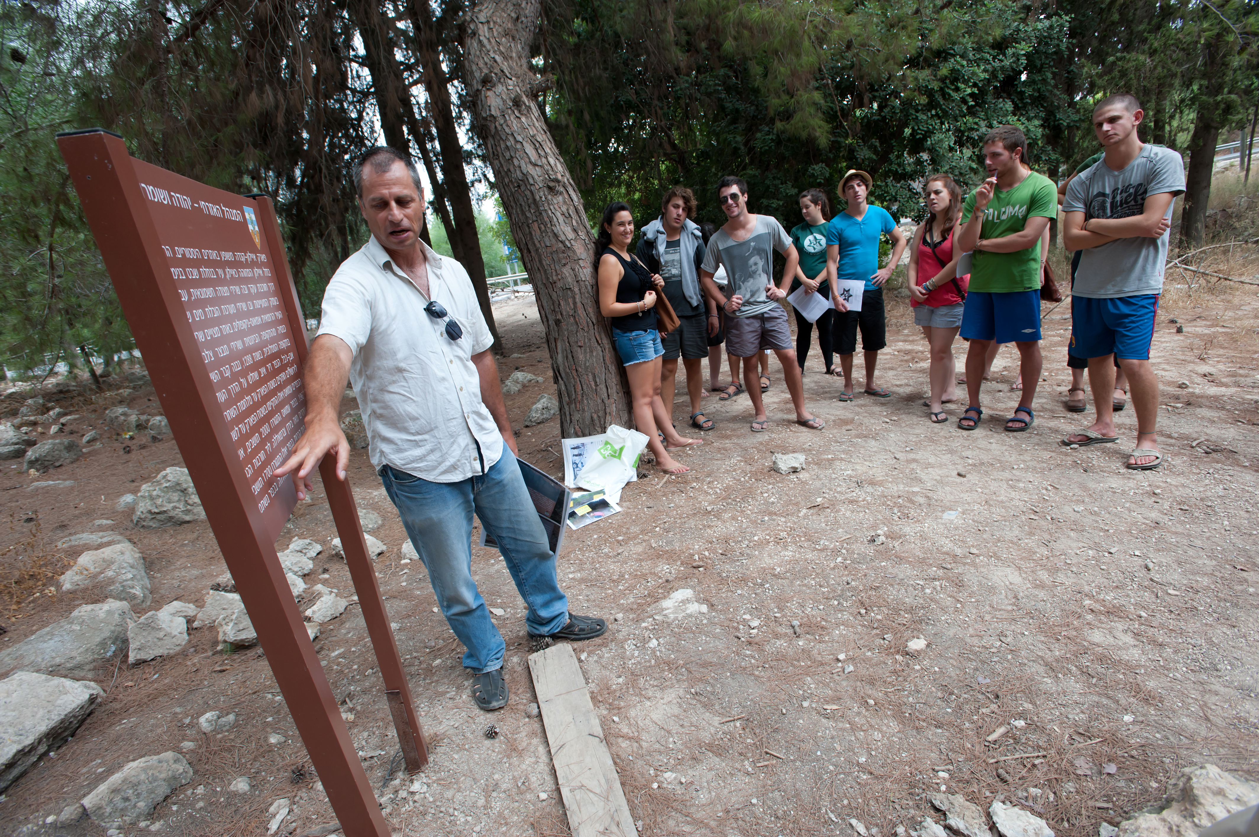 man pointing at sign for group