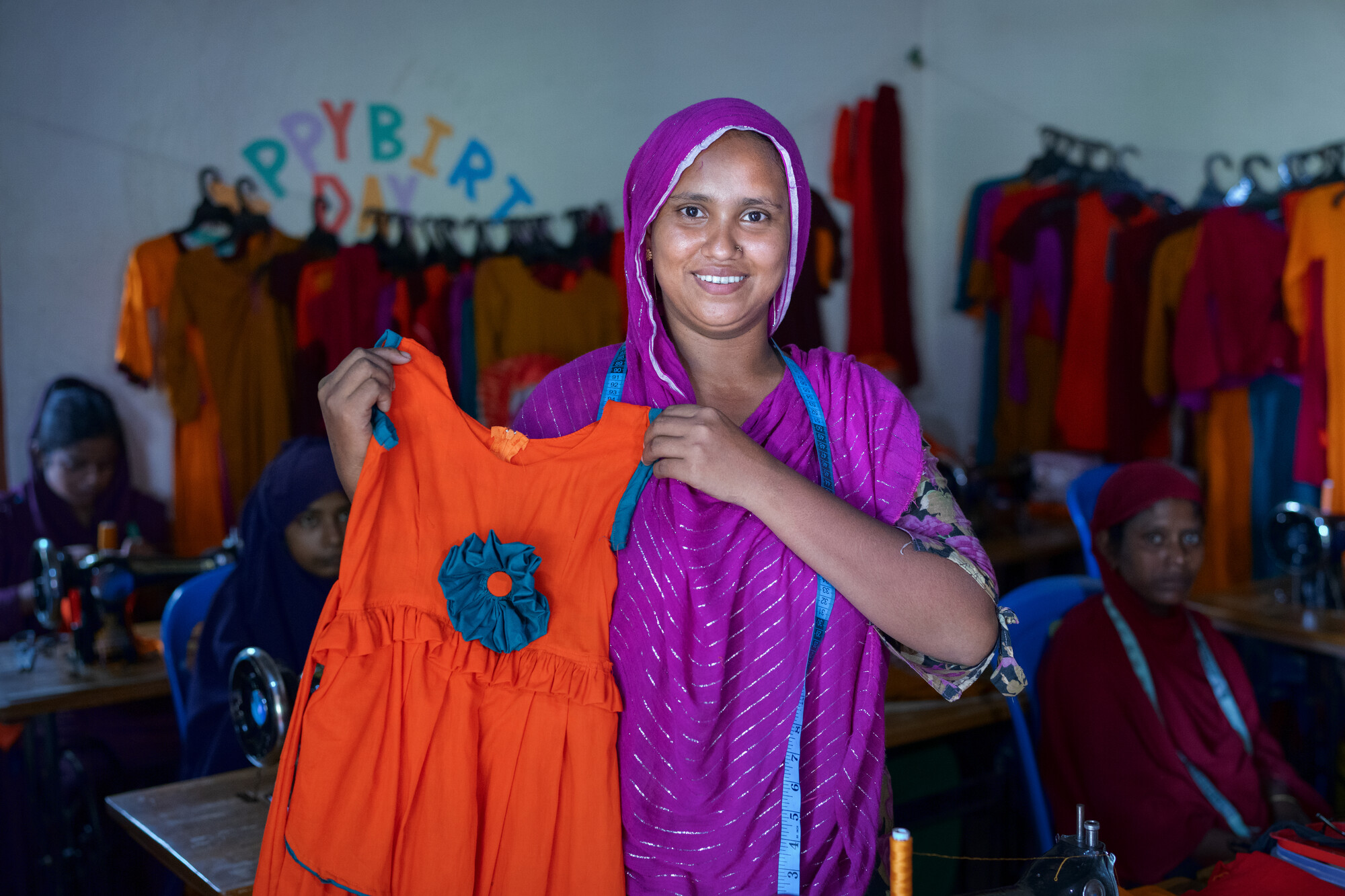 Seamstress holding child's dress