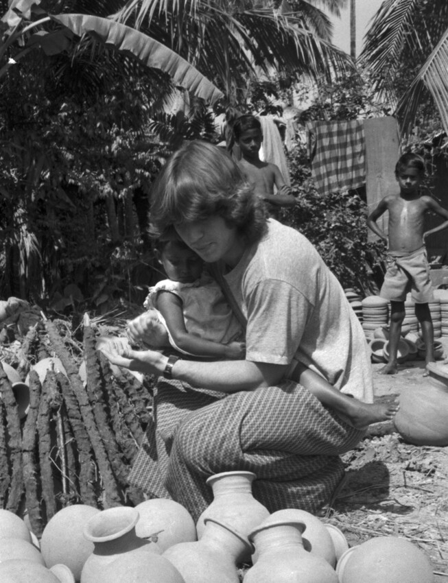 A black and white photo of a man holding a small child