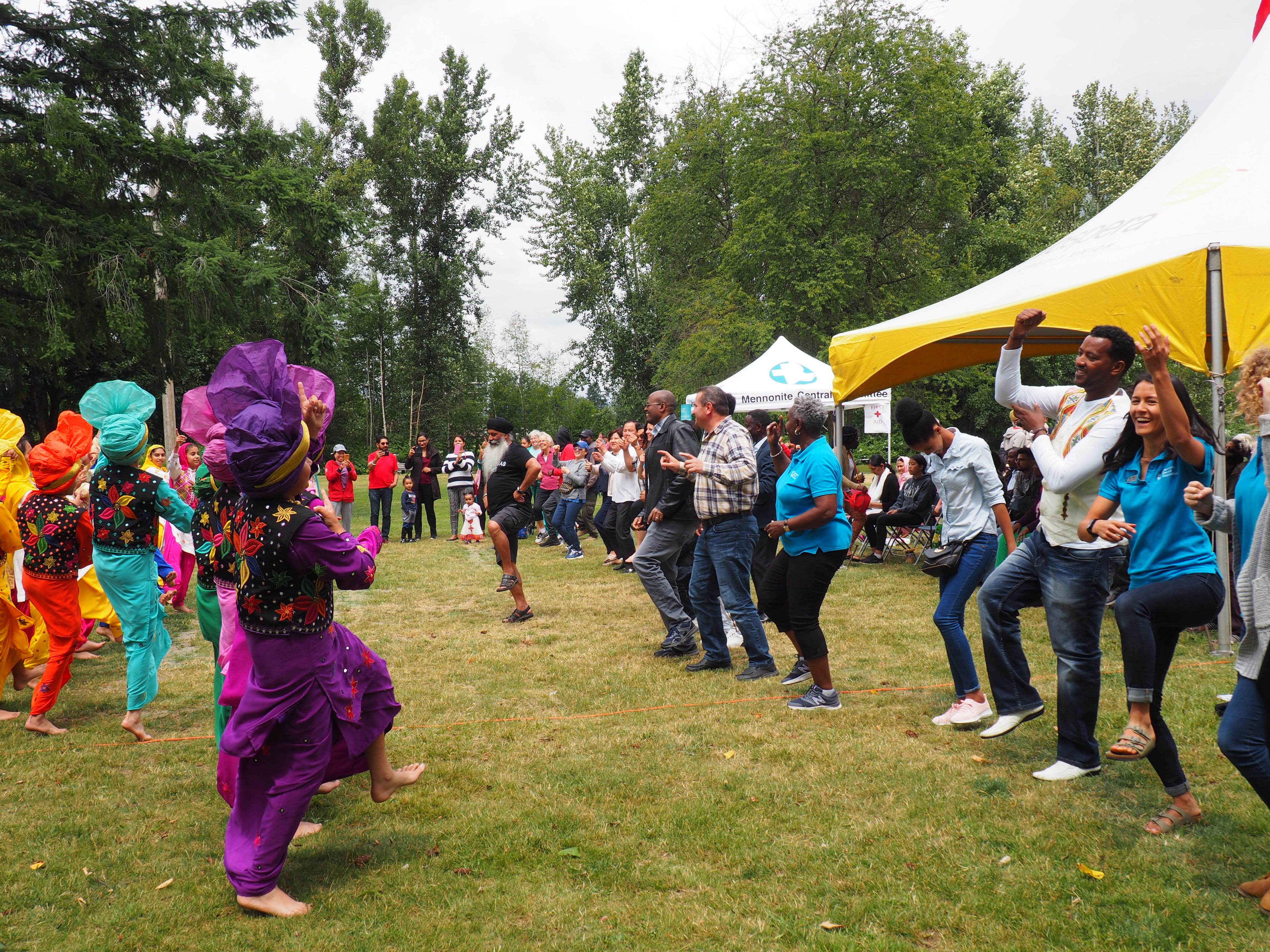 A group of people dancing in a park