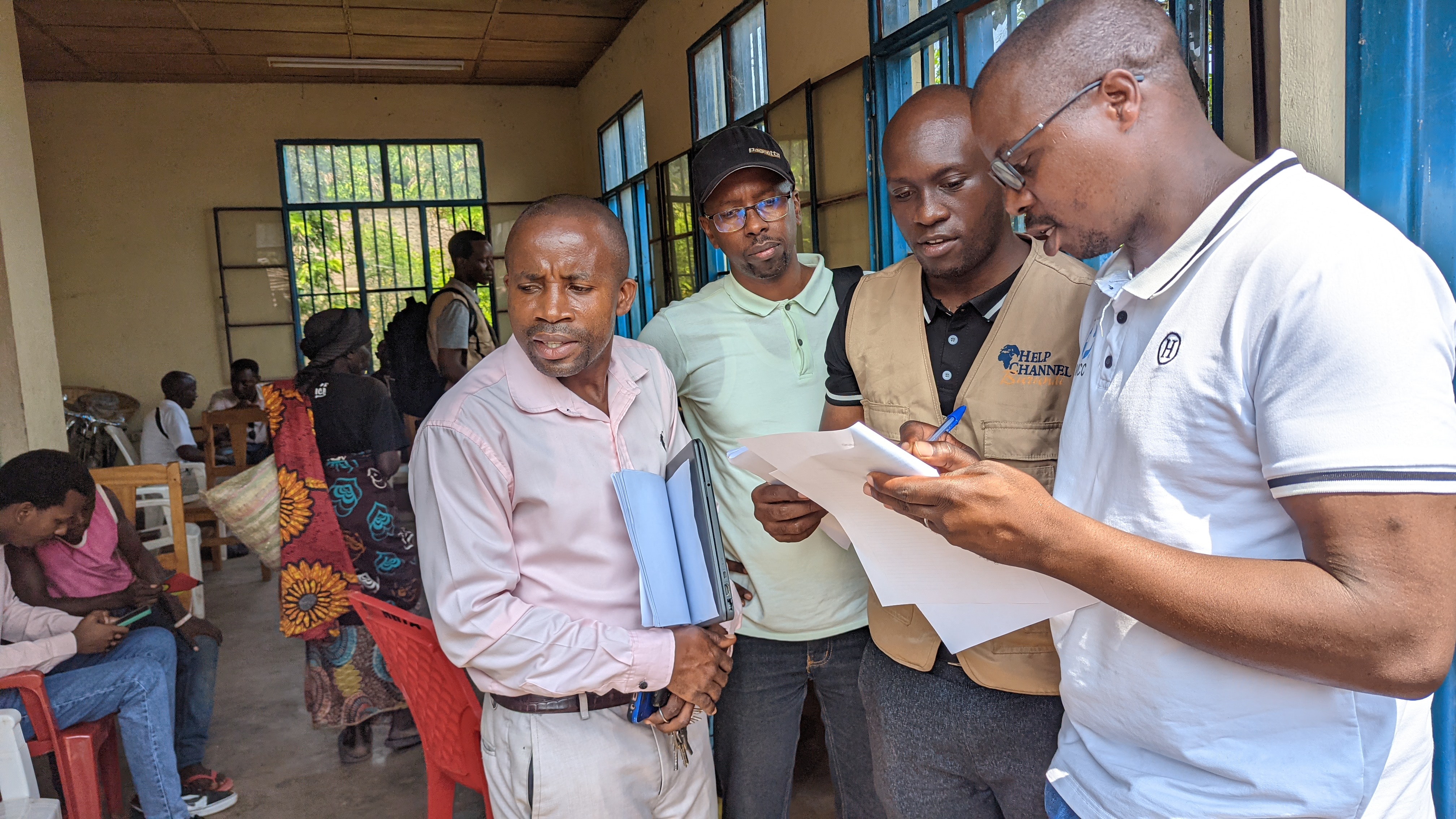 A group of men examine a document