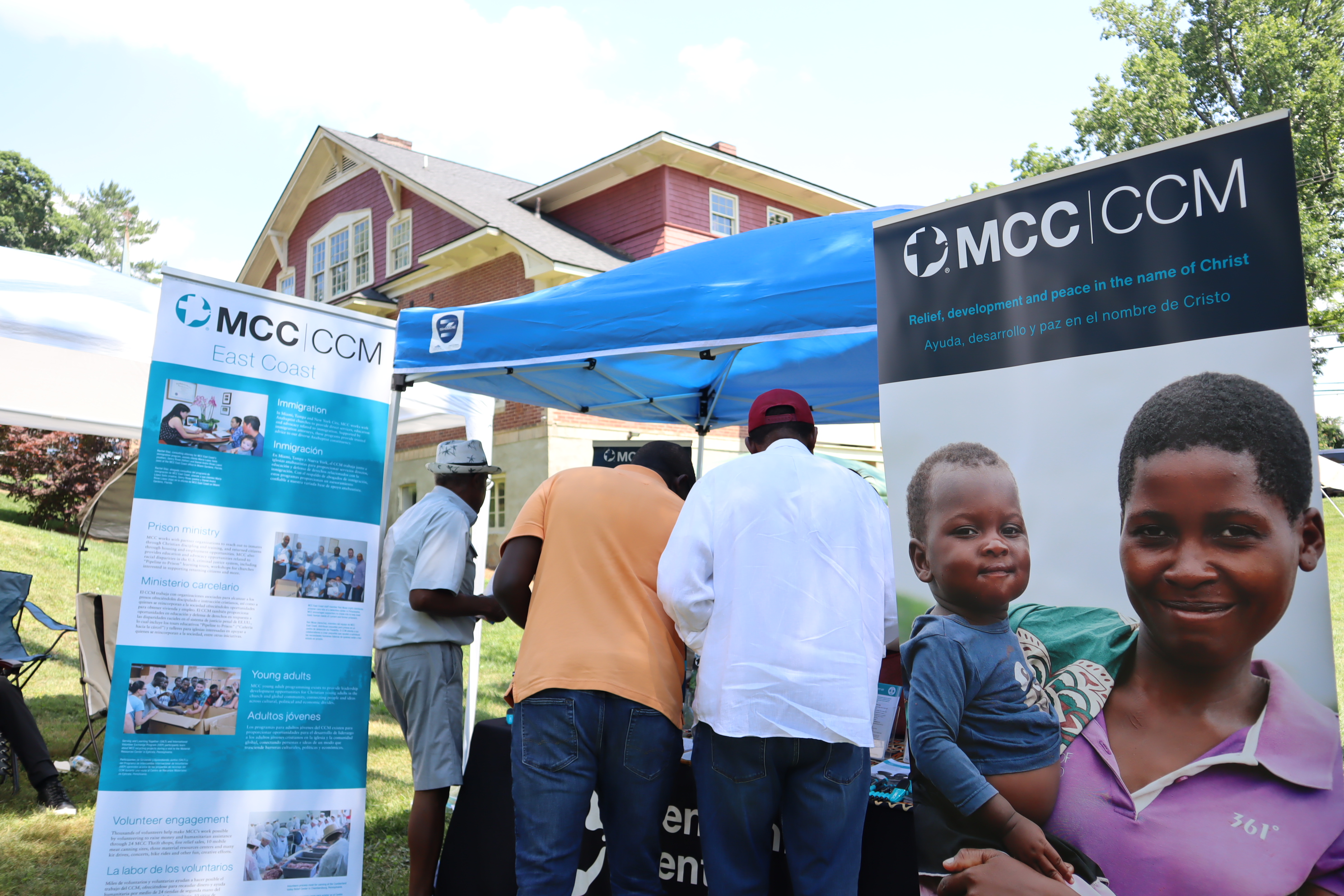 People interacting with the MCC booth. 