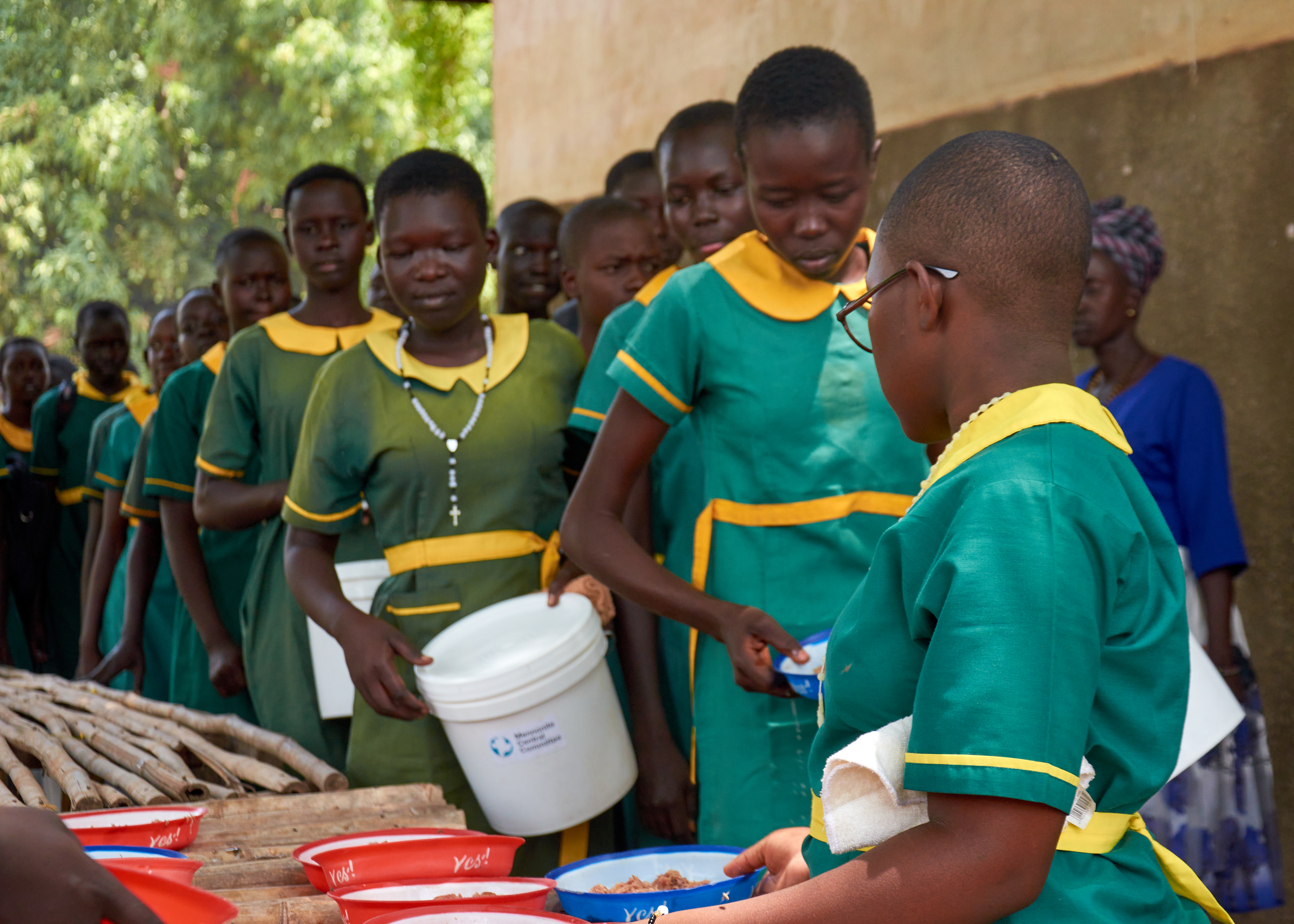 Students in South Sudan line up to receive a school lunch.