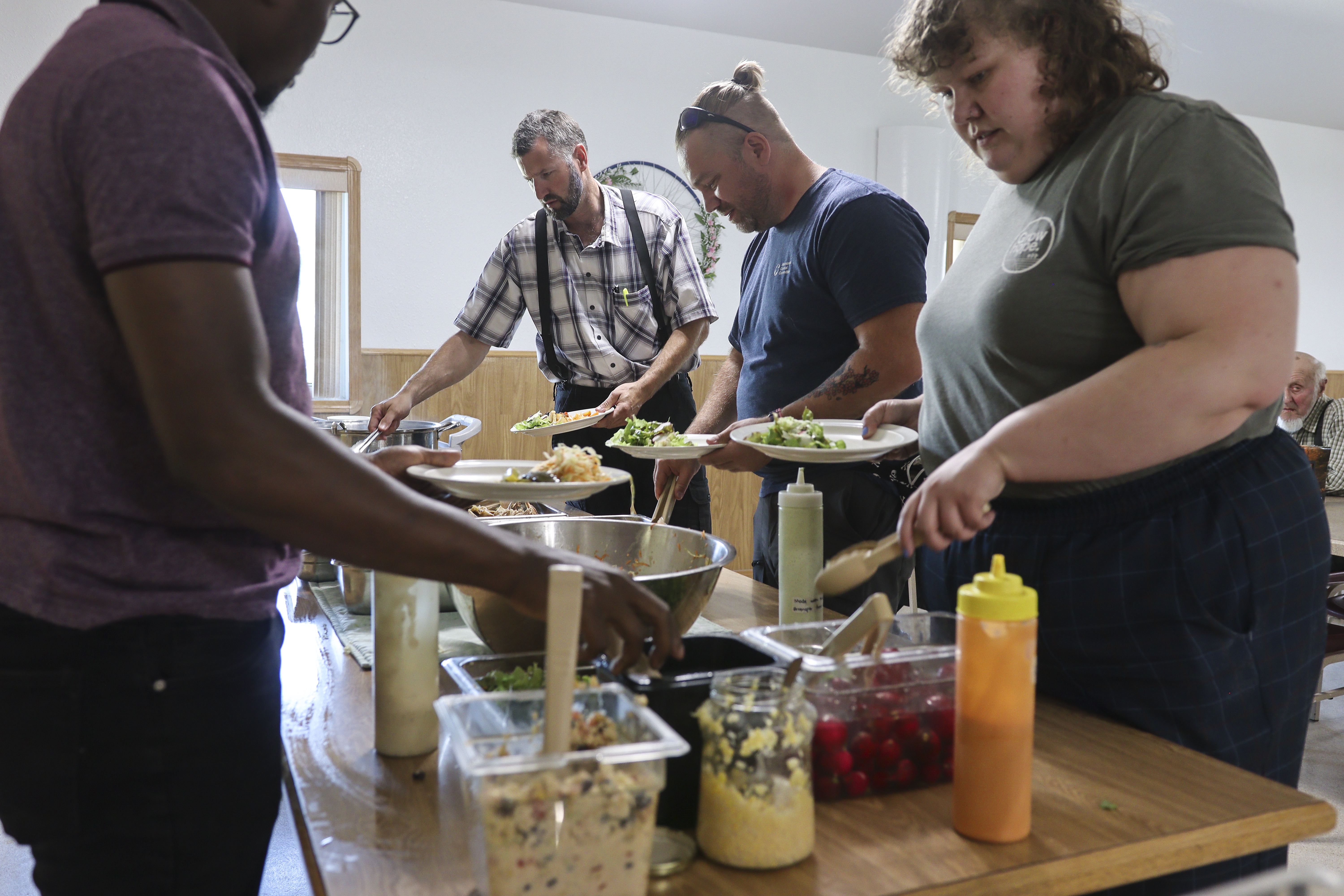 people taking food from a table