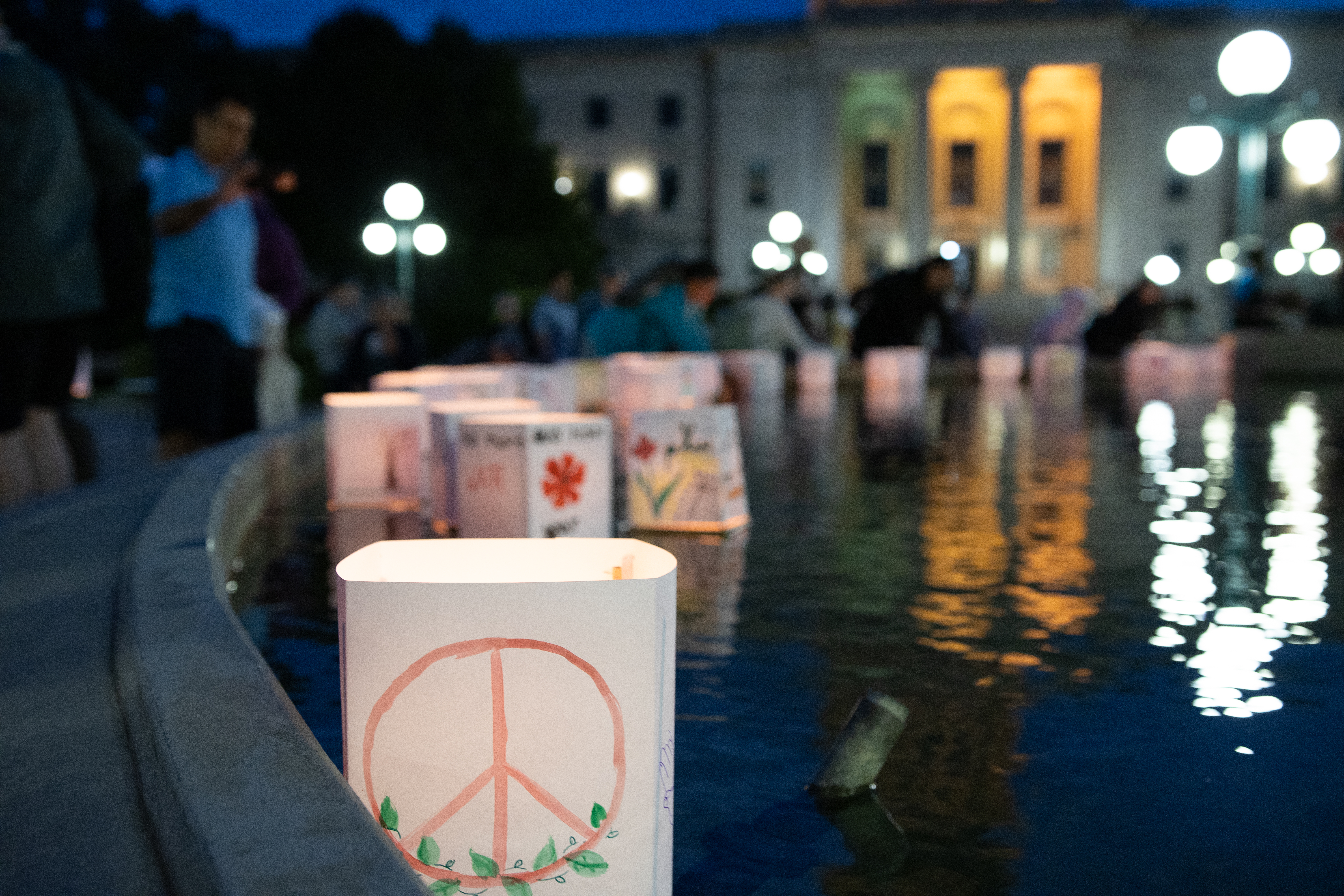 lantern floating on water with peace symbol