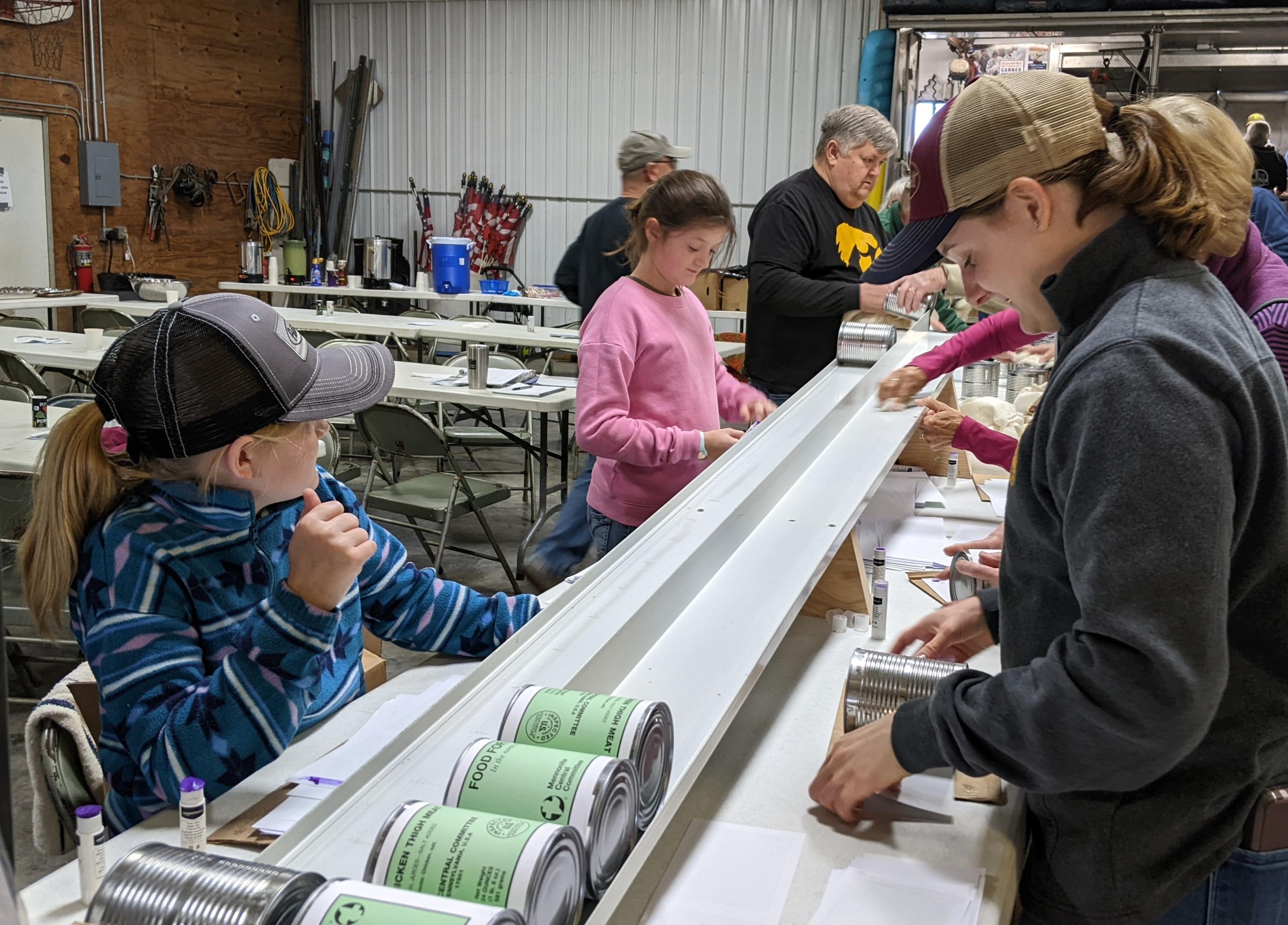 Group of people involving in meat canning.