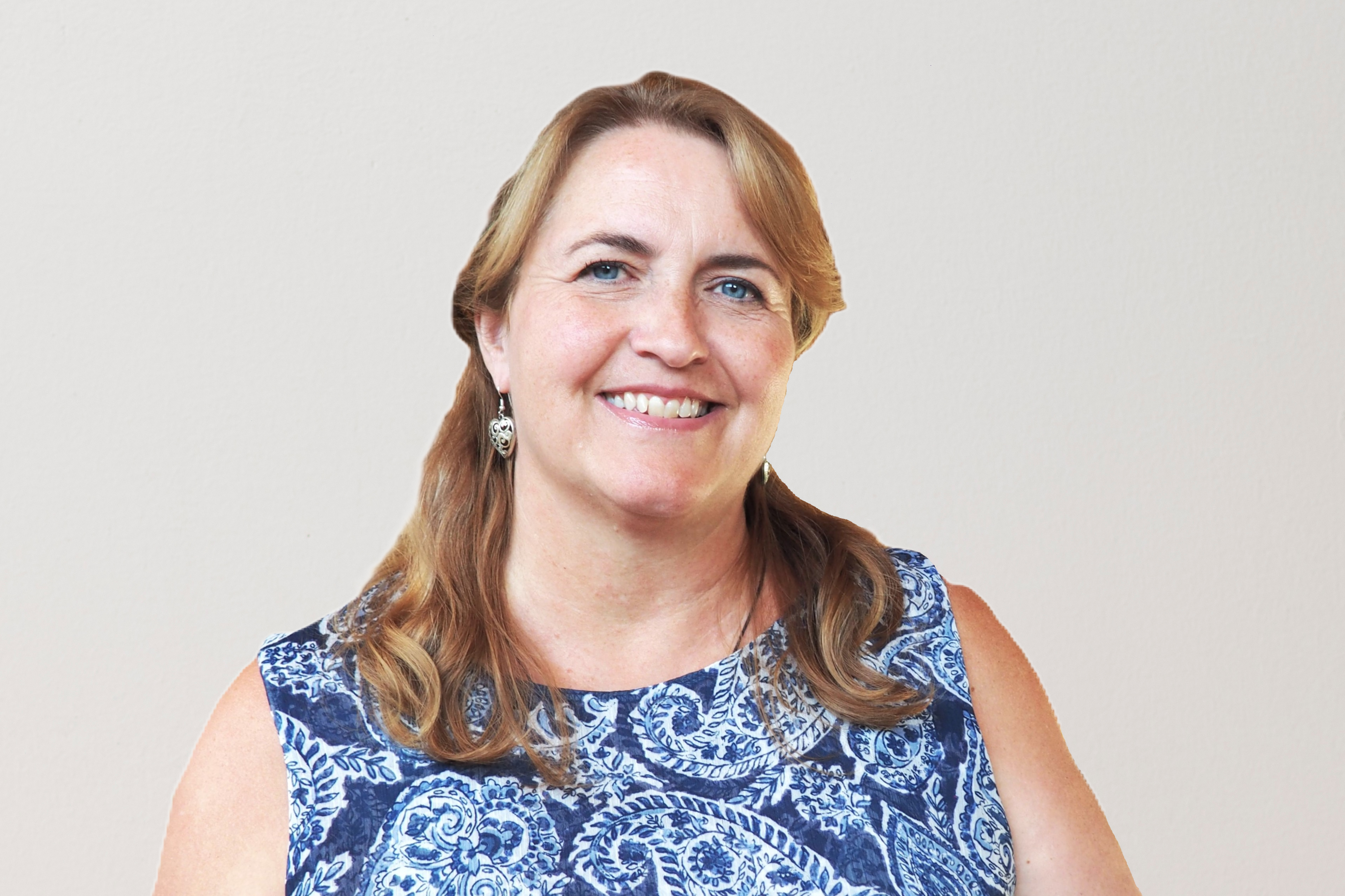 Jill Leusink pictured, a portrait of a woman smiling, blue and white shirt