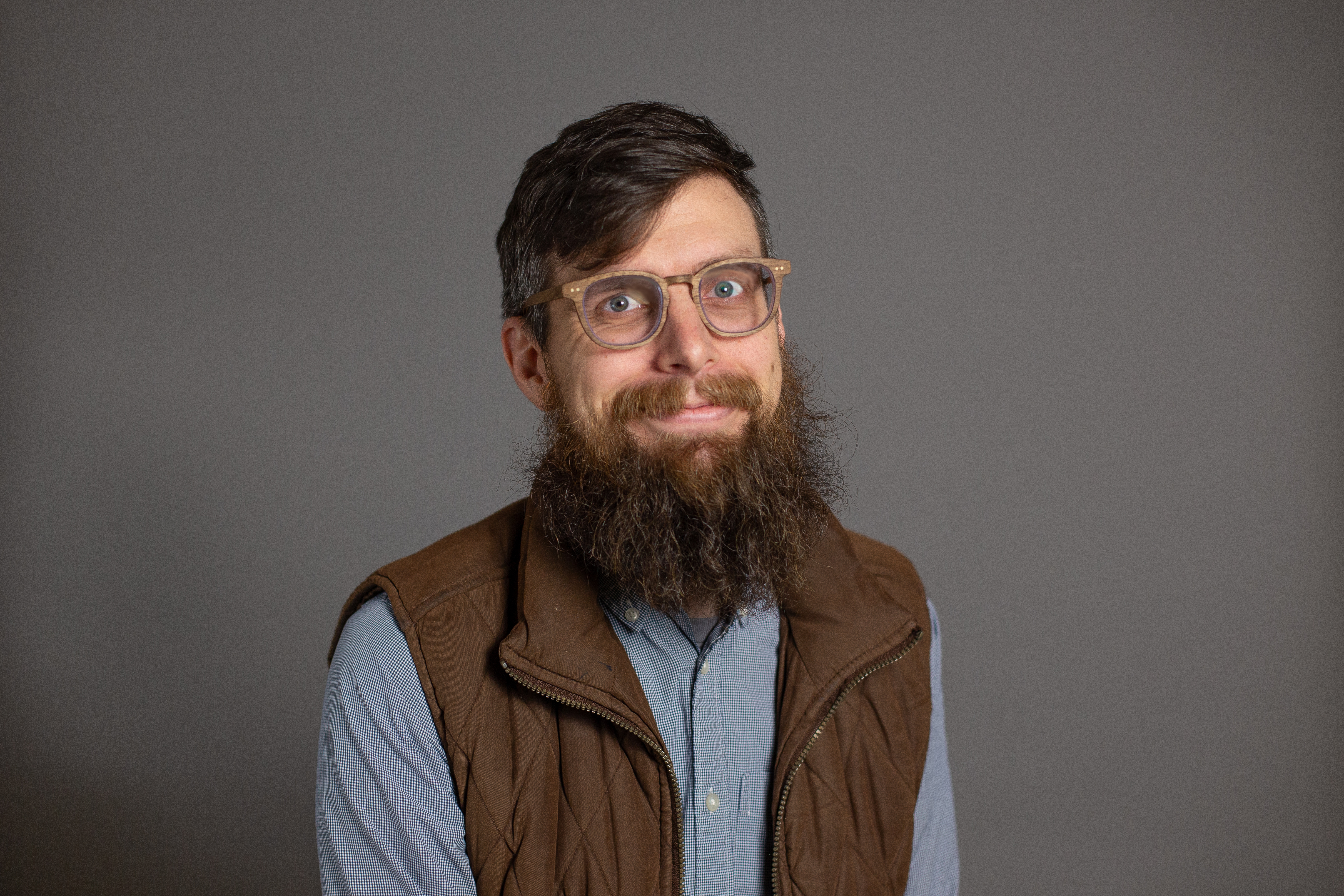 Nick Schuurman pictured, smiling in front of a grey backdrop.