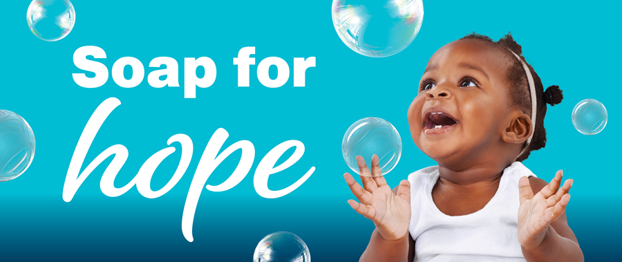 baby laughing at soap bubbles with text Soap for Hope