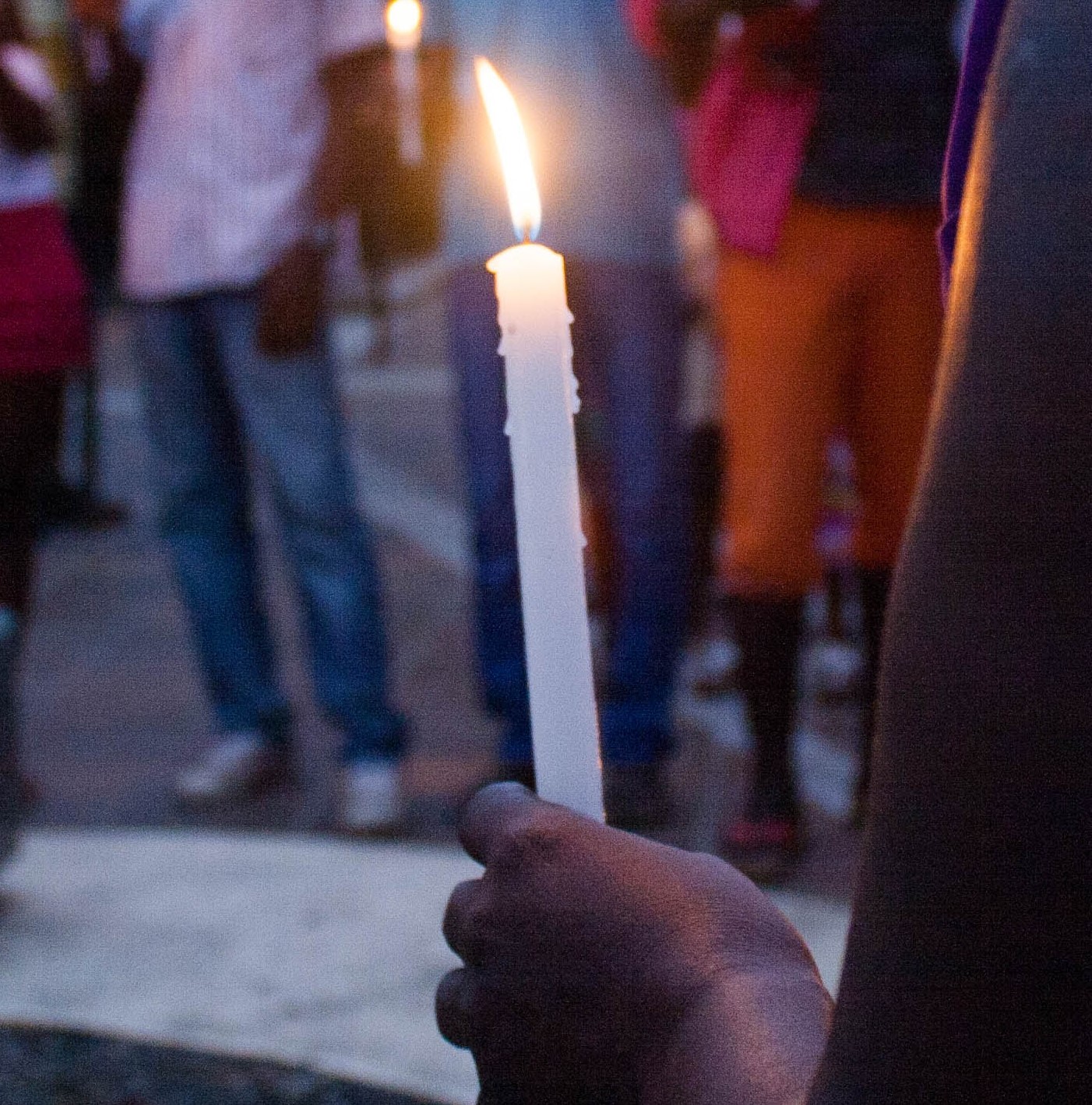 woman's hand holding candle