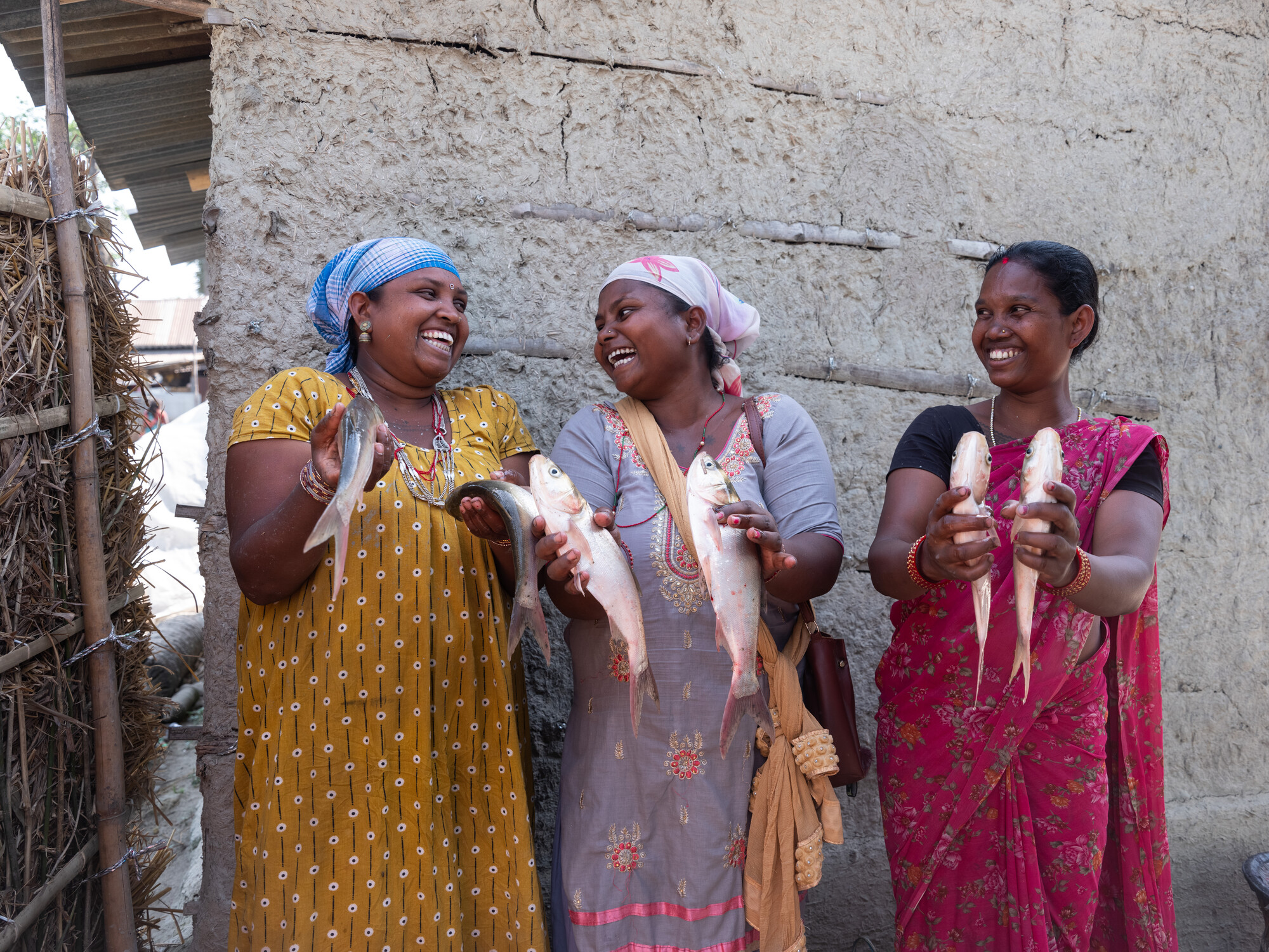 3 women holding fish