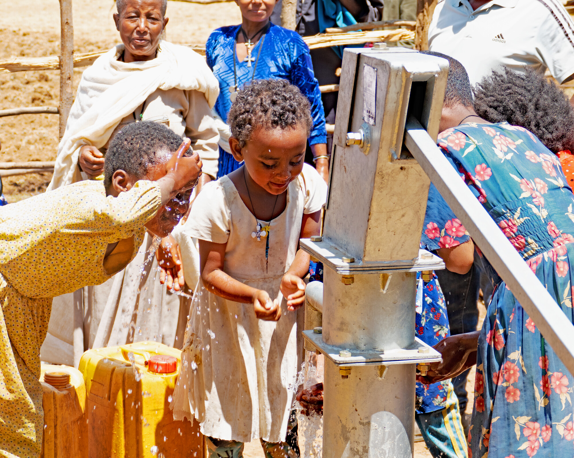 Group of children at a well.