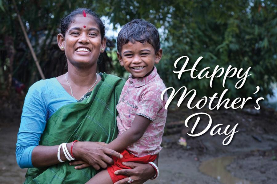 A smiling woman holding a child with the words "Happy Mother's Day"