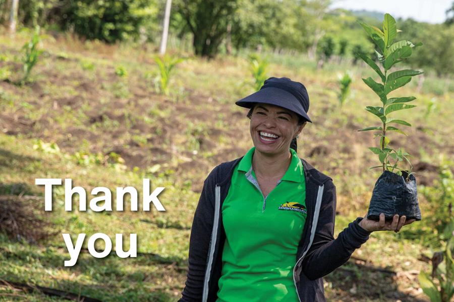 A woman holding a sapling with the word "Thank you"