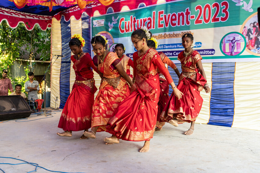 Group of people wearing red perform a dance.