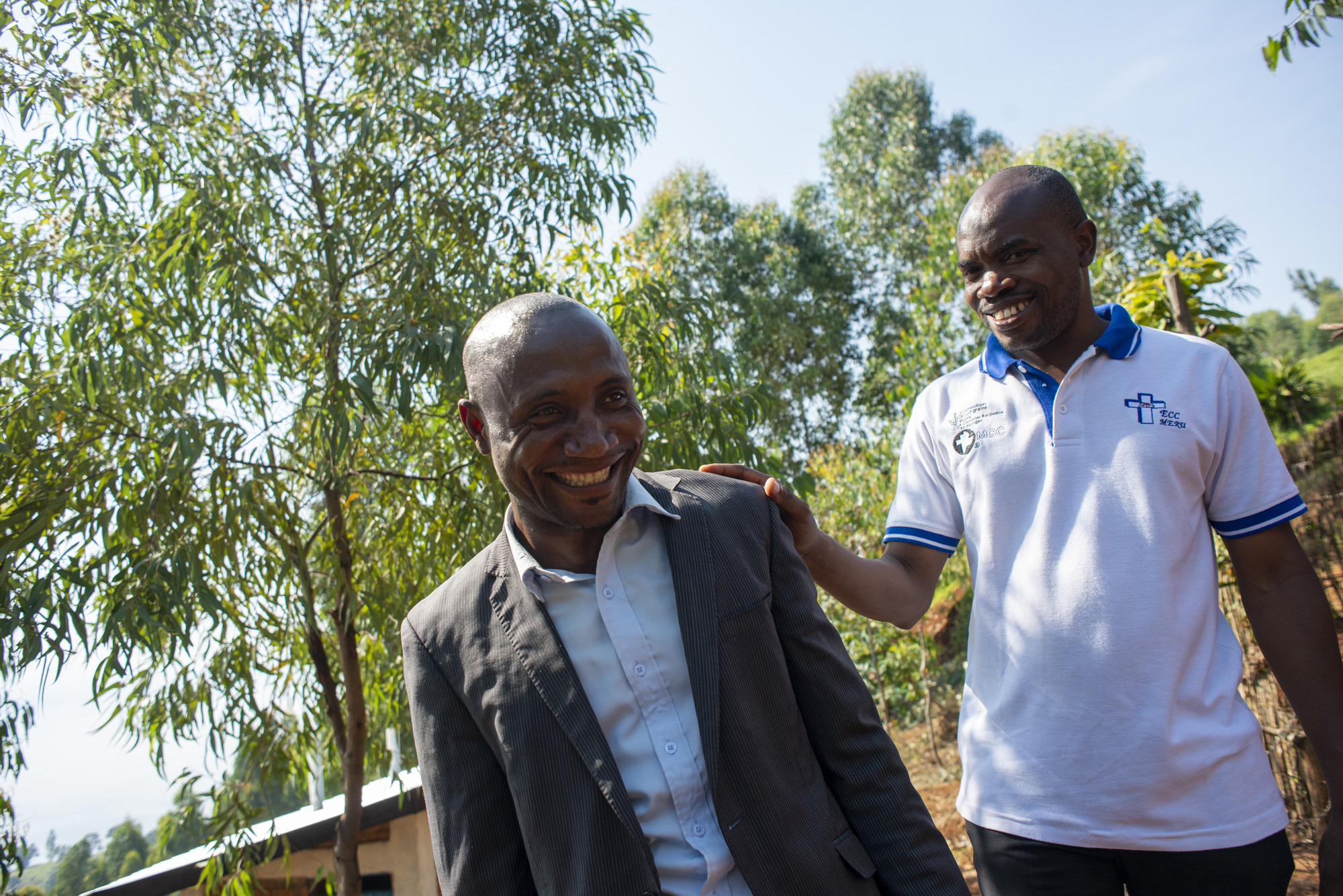 Mulanda “Jimmy” Juma (right), the MCC representative of the Democratic Republic of the Congo and Angola, talks with Principal Pascal Birhahwa Muhindo at the Katuze Secondary School in Mosho III villag