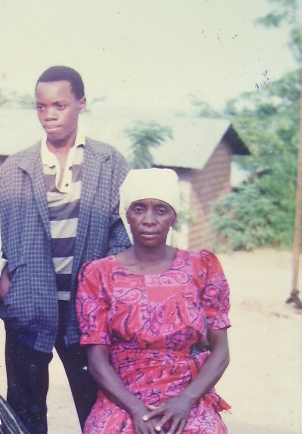 Mulanda Juma and his mother, Mwangaza Lotombo Wa M'landa, pose for a photo in 1985, in front of their home in I'amba Village in the Democratic Republic of the Congo. His mother gave birth to him just