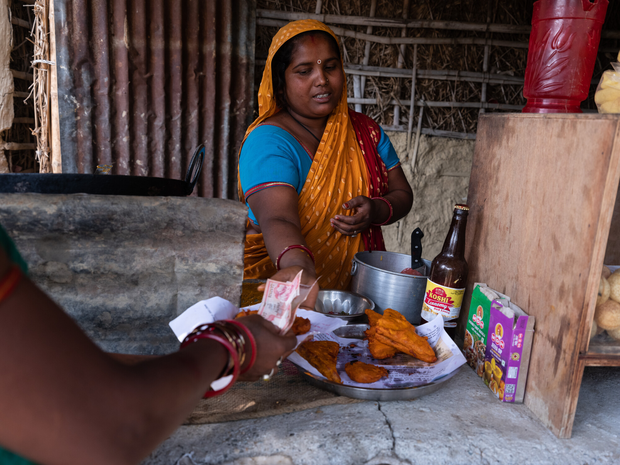 Suman Devi Paswan(31) is working at her shop in Jahada Rural Municipality- 2, Morang, Nepal on Wednesday, April 24, 2024. She is a member of the Shree Ram Janaki Farmers group. She runs small shop nea